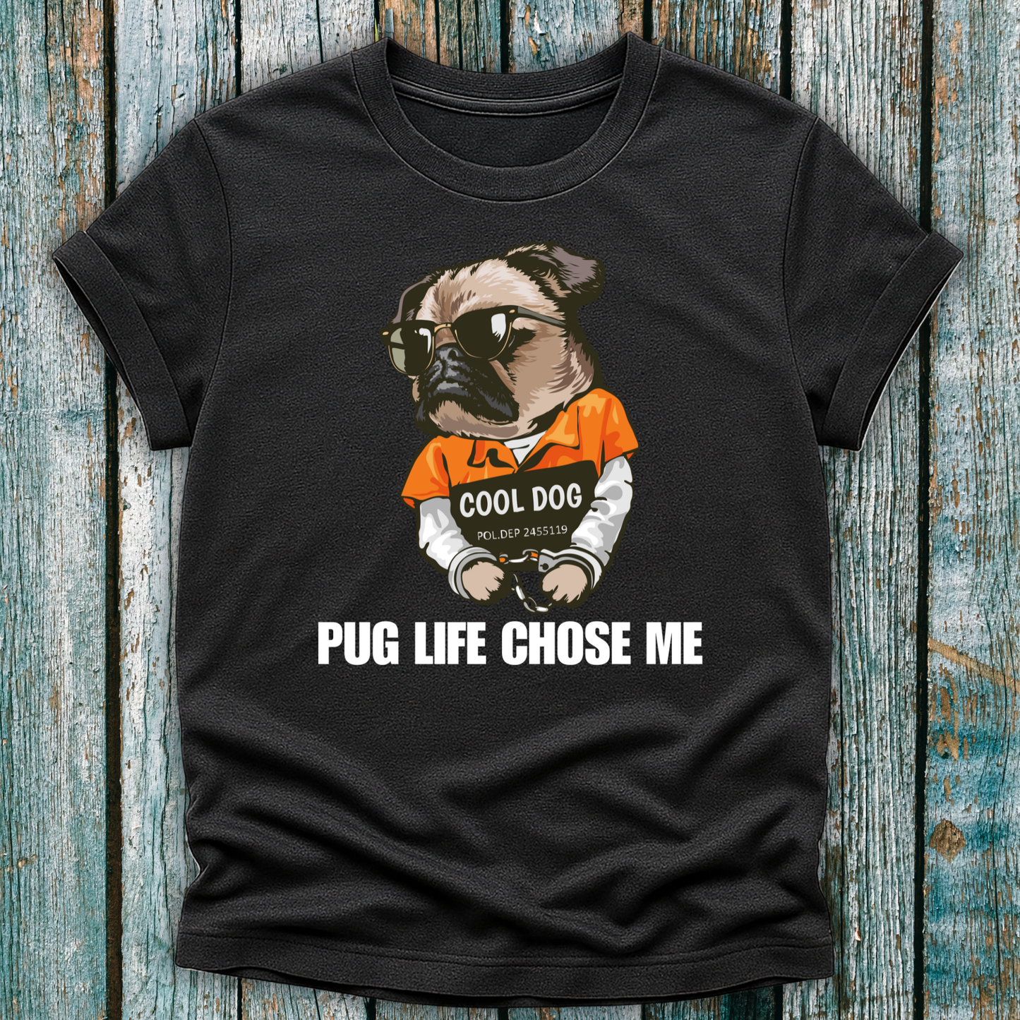 Black t-shirt with a pug graphic and text on a wooden surface