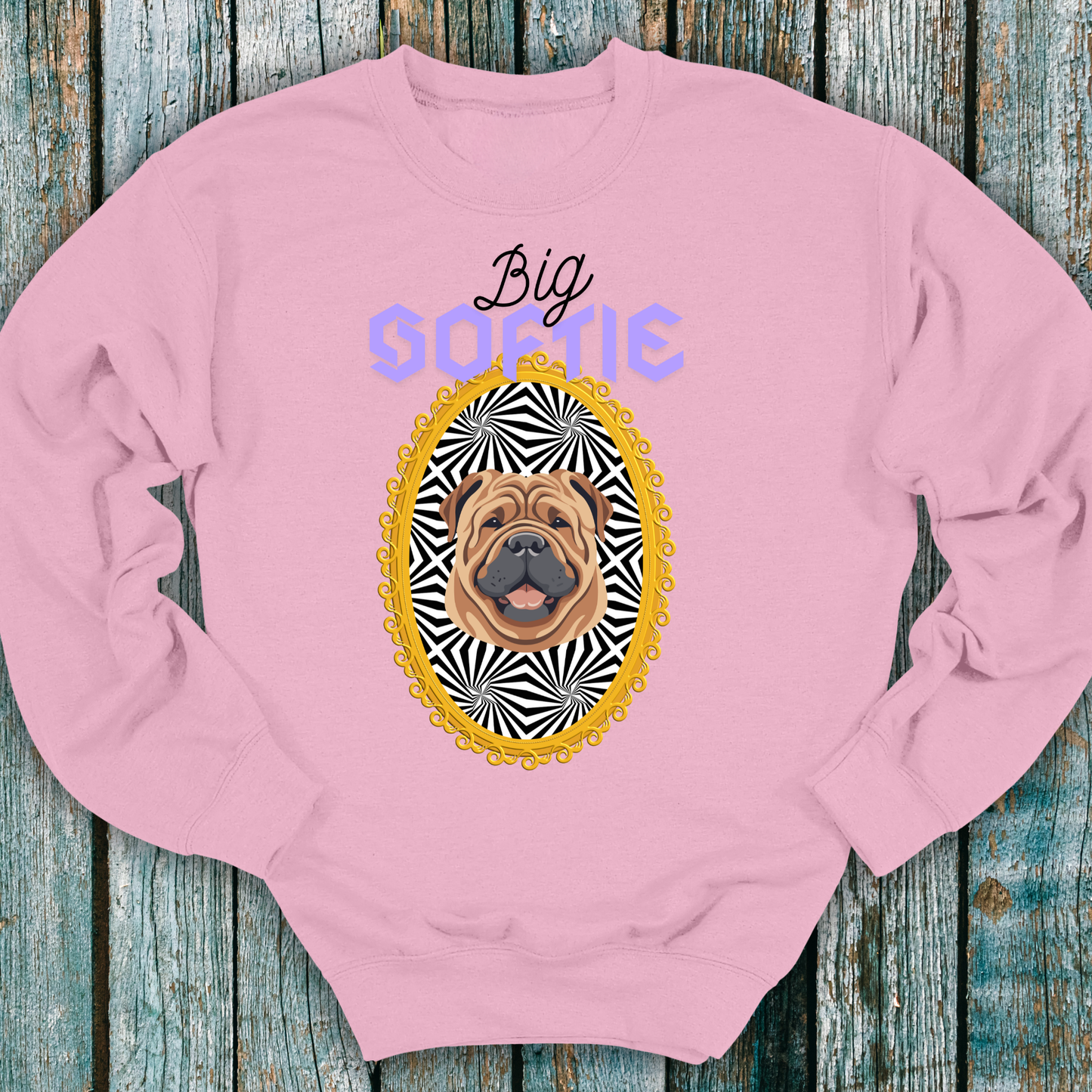 Pink sweatshirt with a Shar_Pei dog graphic and 'Big Softie' text on a wooden surface