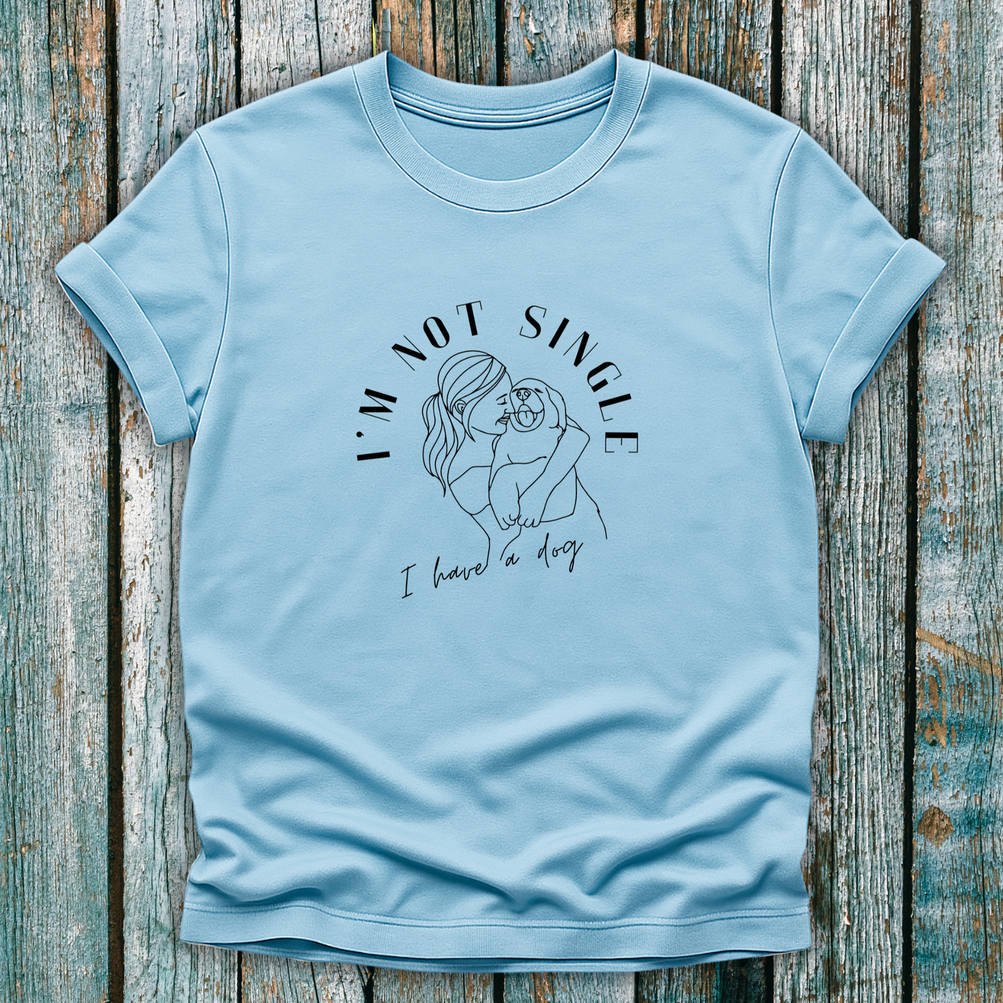 Blue T-Shirt with I'm not single I have a dog and lady hugging a dog