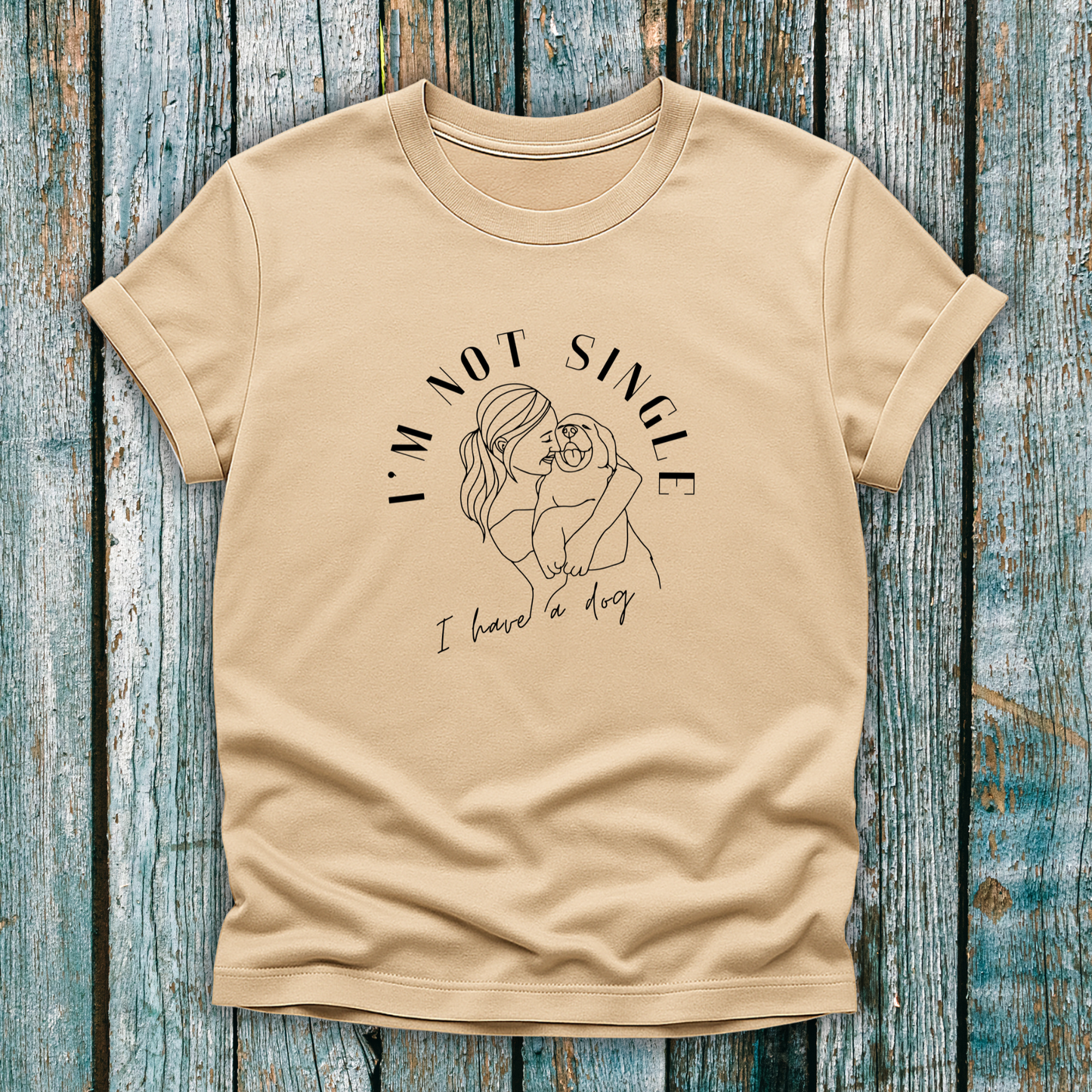 Beige T-Shirt with I'm not single I have a dog and lady hugging a dog