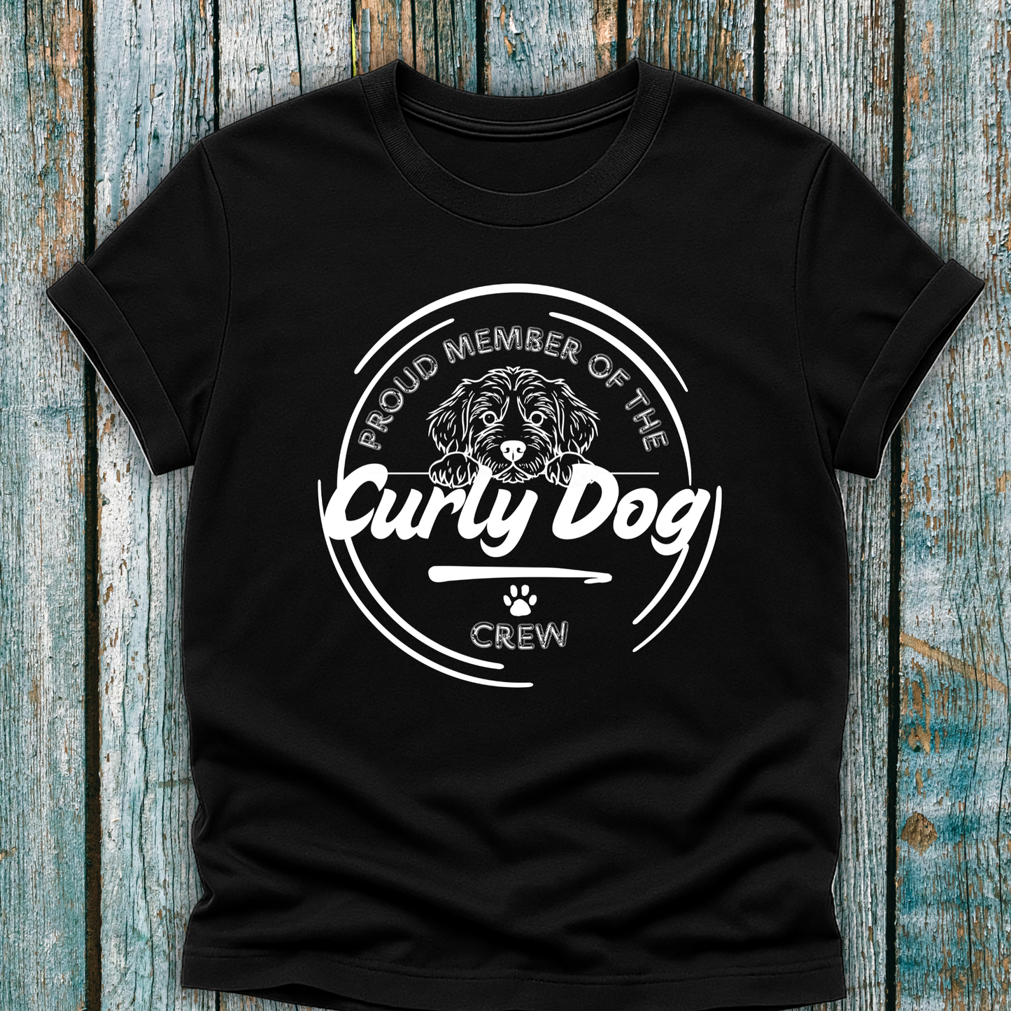 Black t-shirt with 'Proud Member of the Curly Dog Crew' design on a wooden background