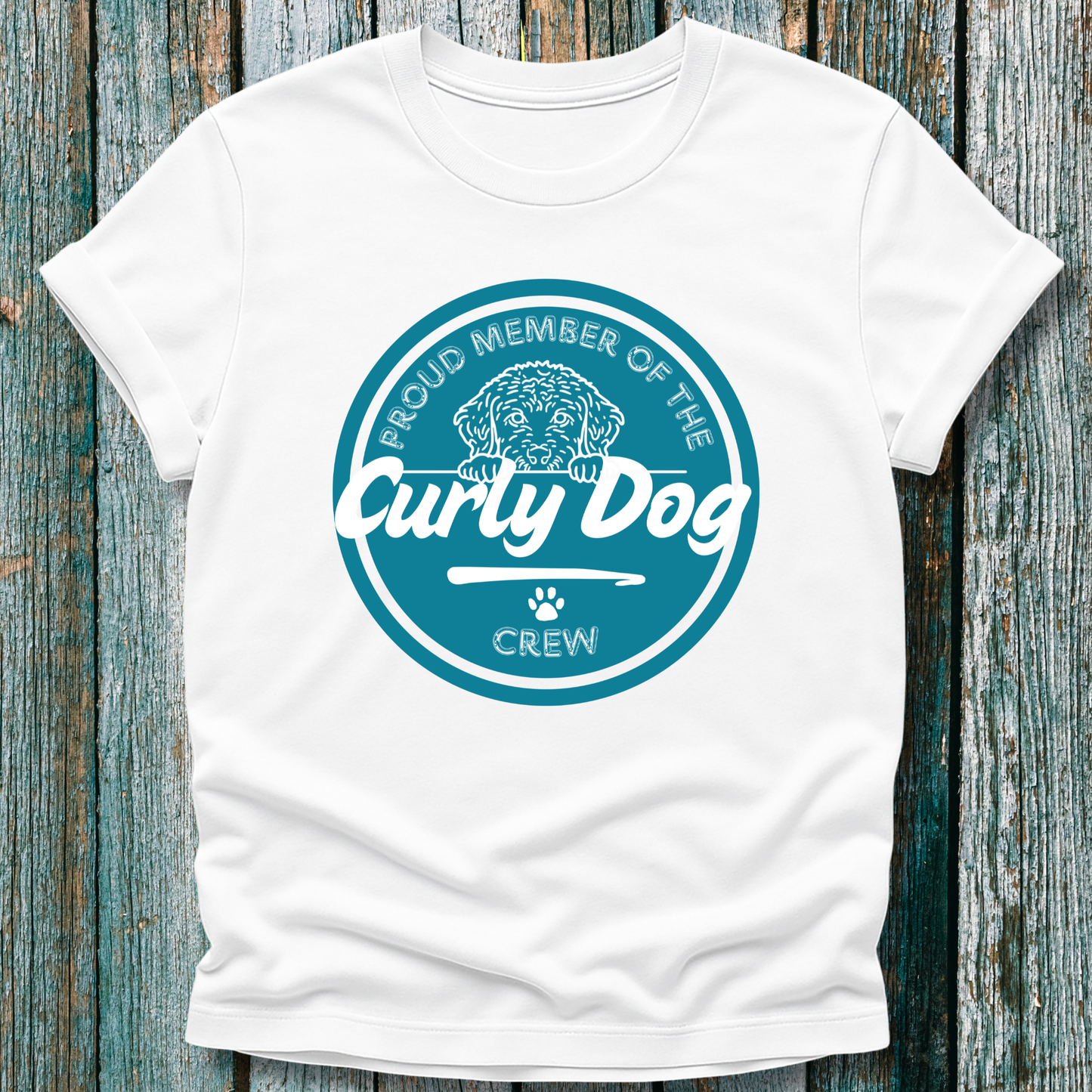 White t-shirt with 'Proud Member of the Curly Dog Crew' design on a wooden surface