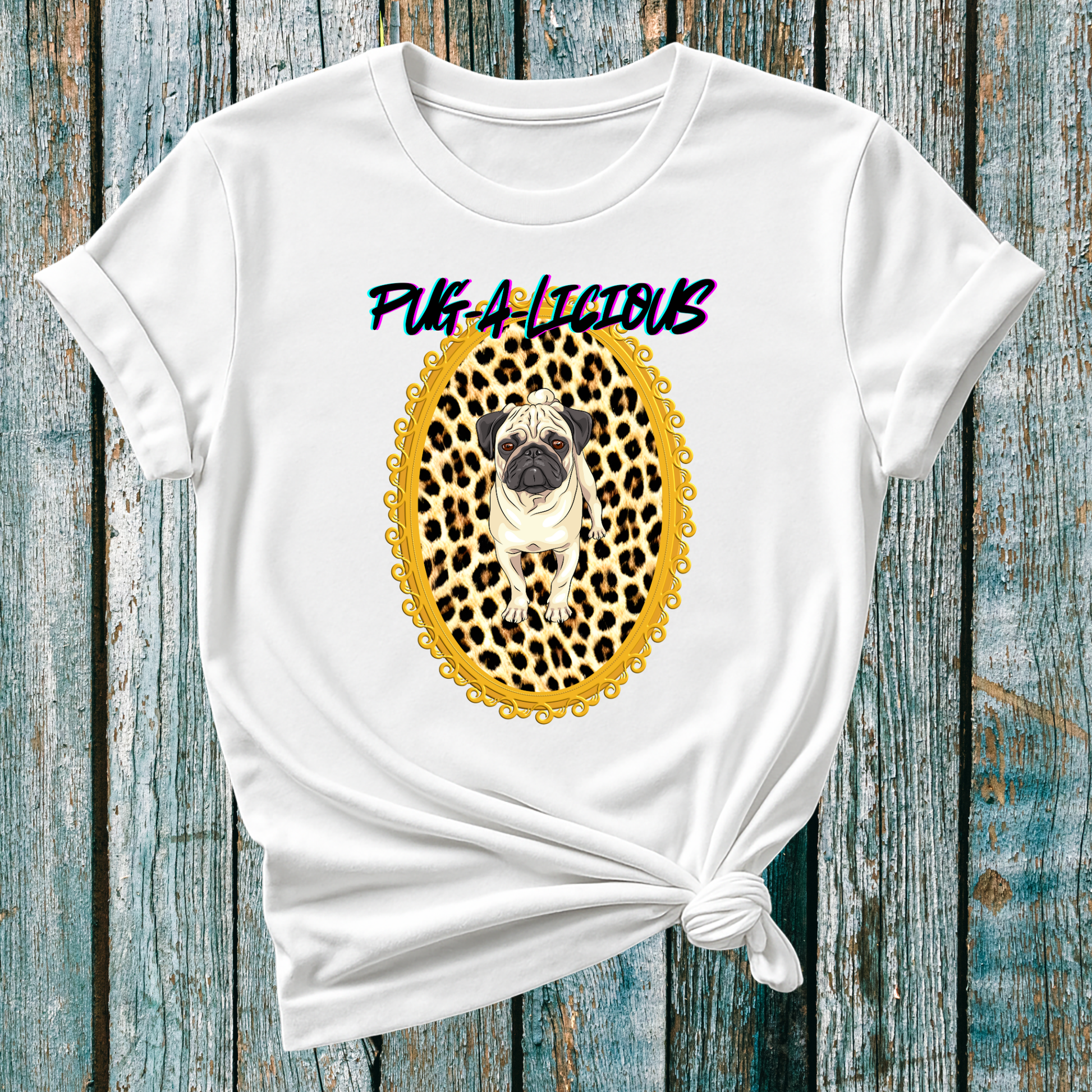 White t-shirt with a pug graphic and 'Pug-licious' text on a wooden surface