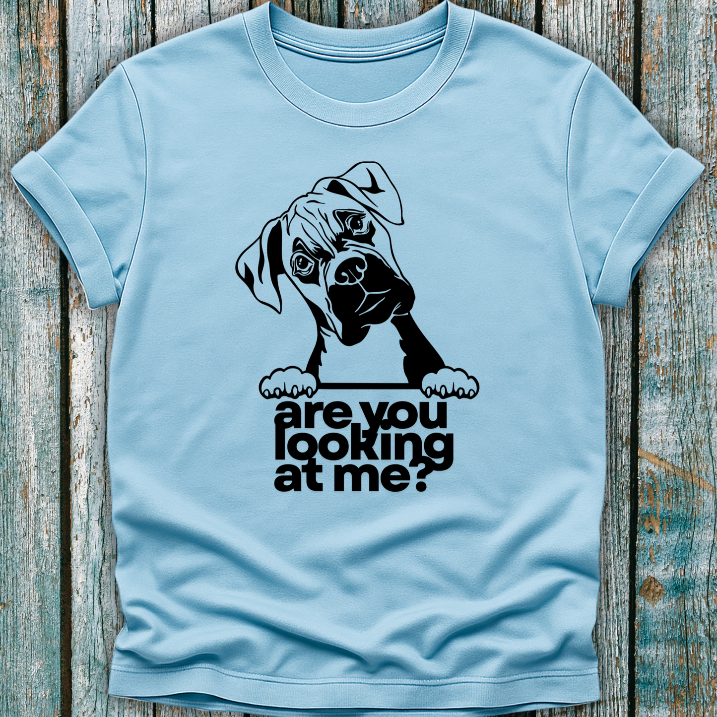 Blue t-shirt with a graphic of a boxer dog and text 'are you looking at me?' on a wooden surface.