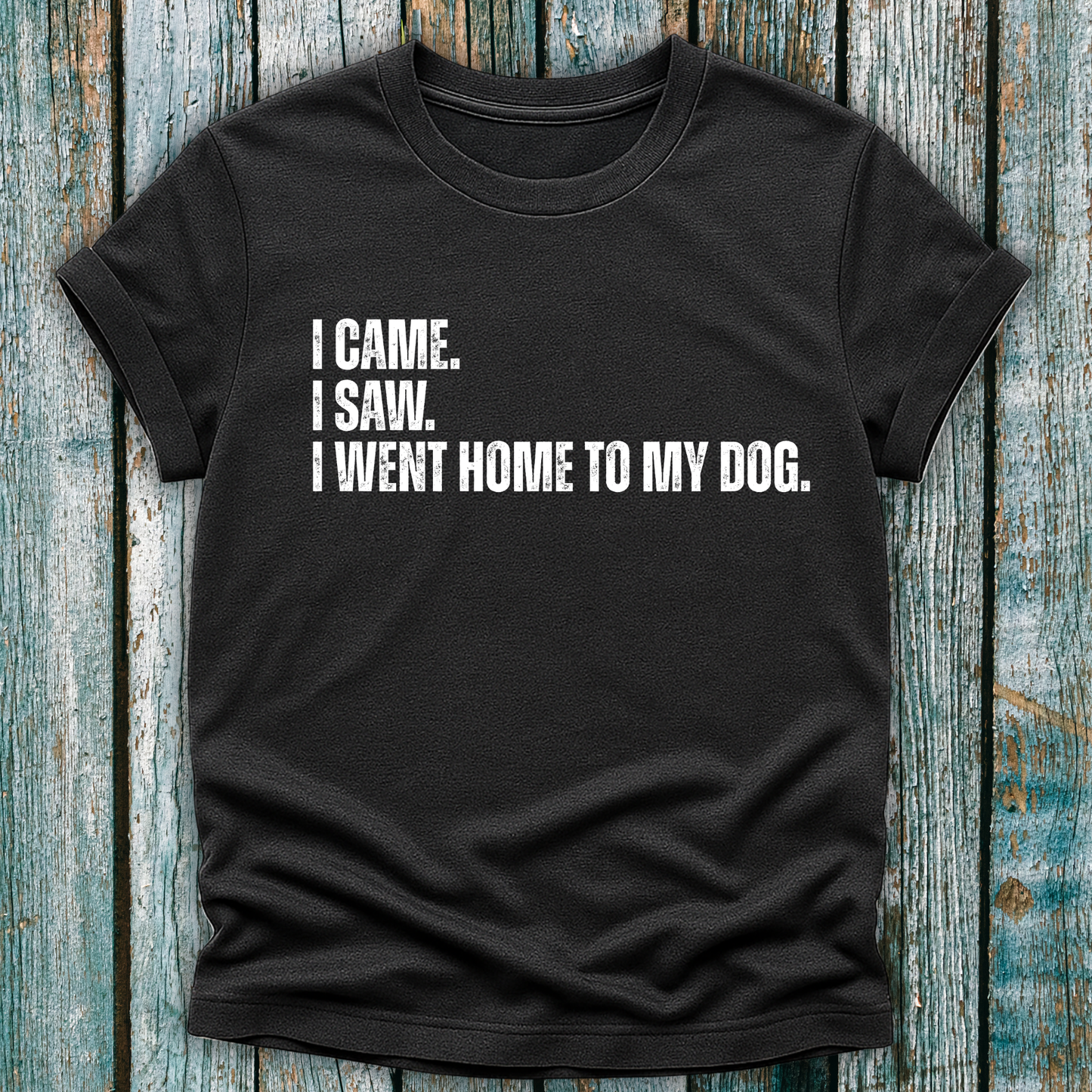 Dark Gray t-shirt with humorous text I came. I saw. I went home to my dog on a wooden surface