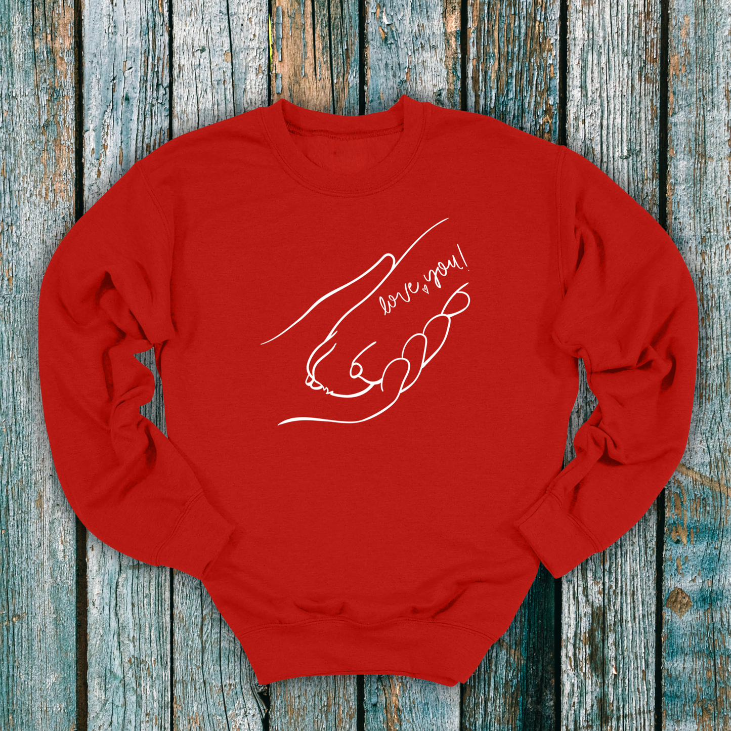 Red sweatshirt with hand holding a dog paw and 'I love you' message