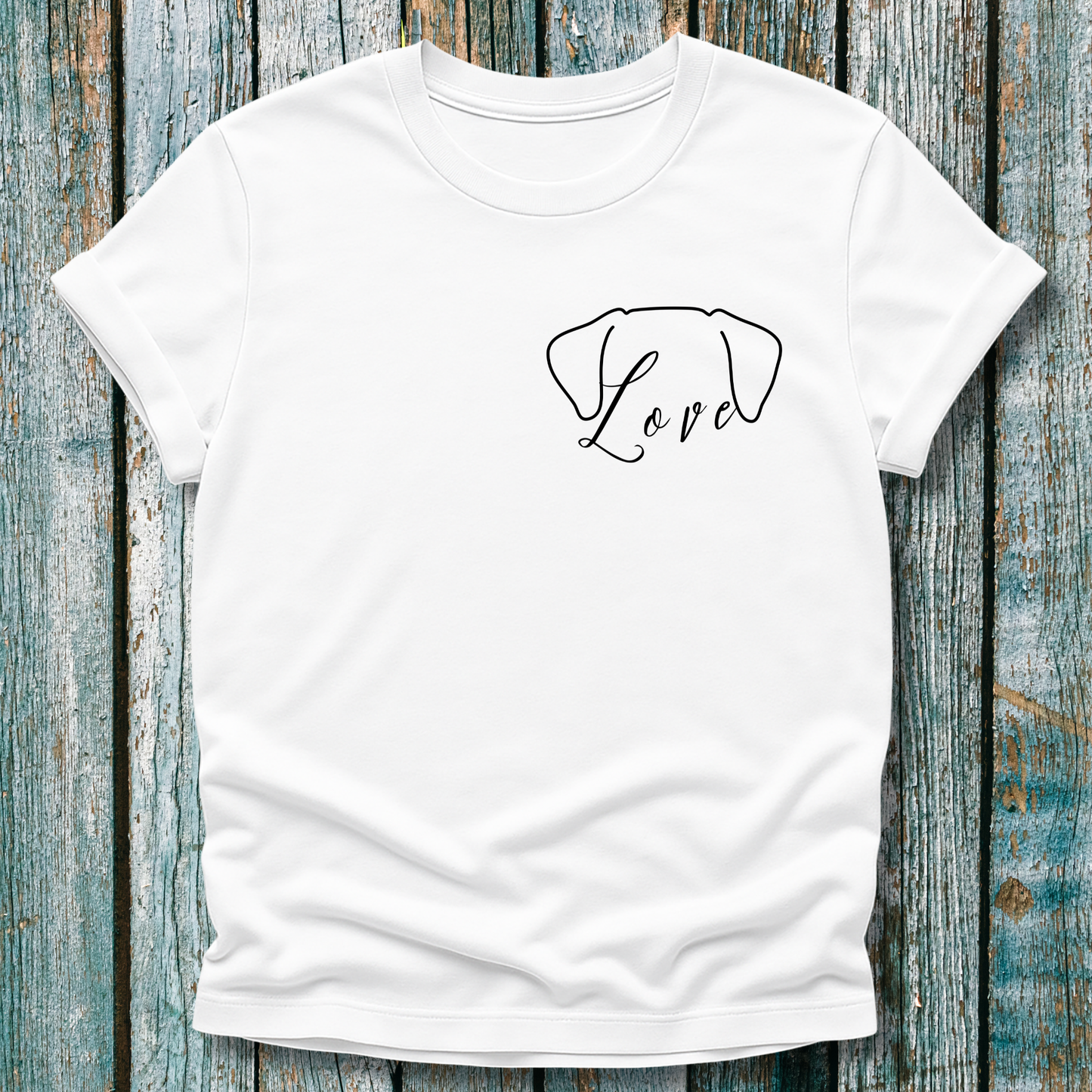 White t-shirt with 'Love' and a dog ears graphic on a wooden surface