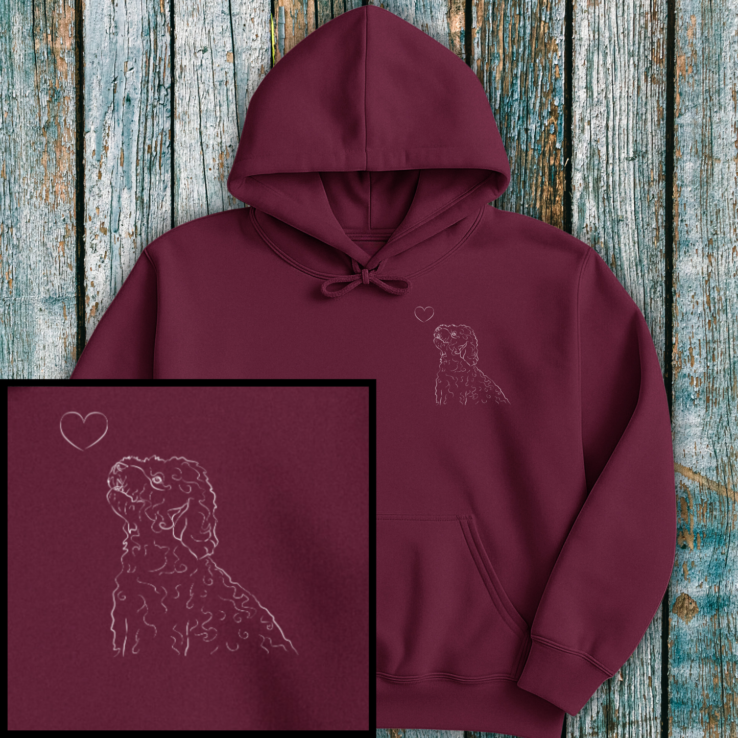 Maroon hoodie with Cockapoo and a heart on a wooden surface