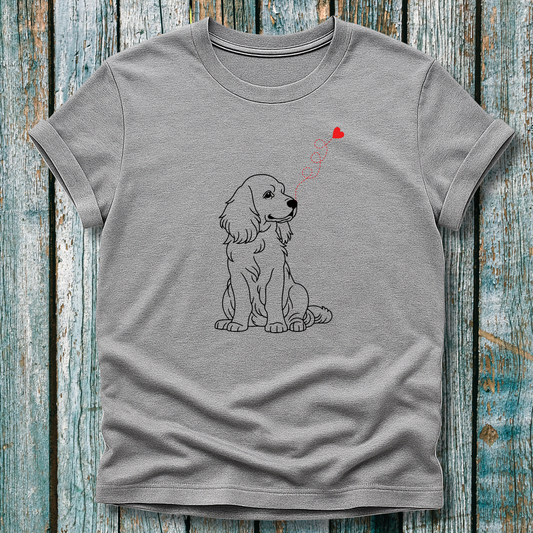 Gray t-shirt with a dog graphic and heart-shap on a wooden surface