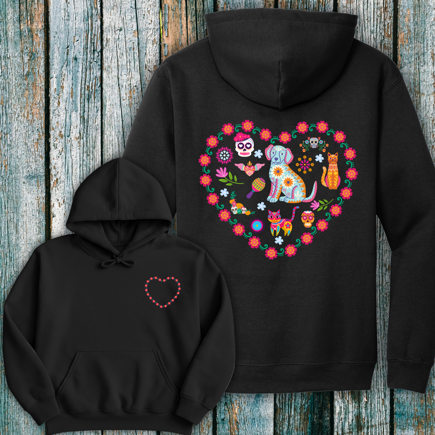 Black hoodie with colorful day of the dead inspired heart graphic design on a wooden surface