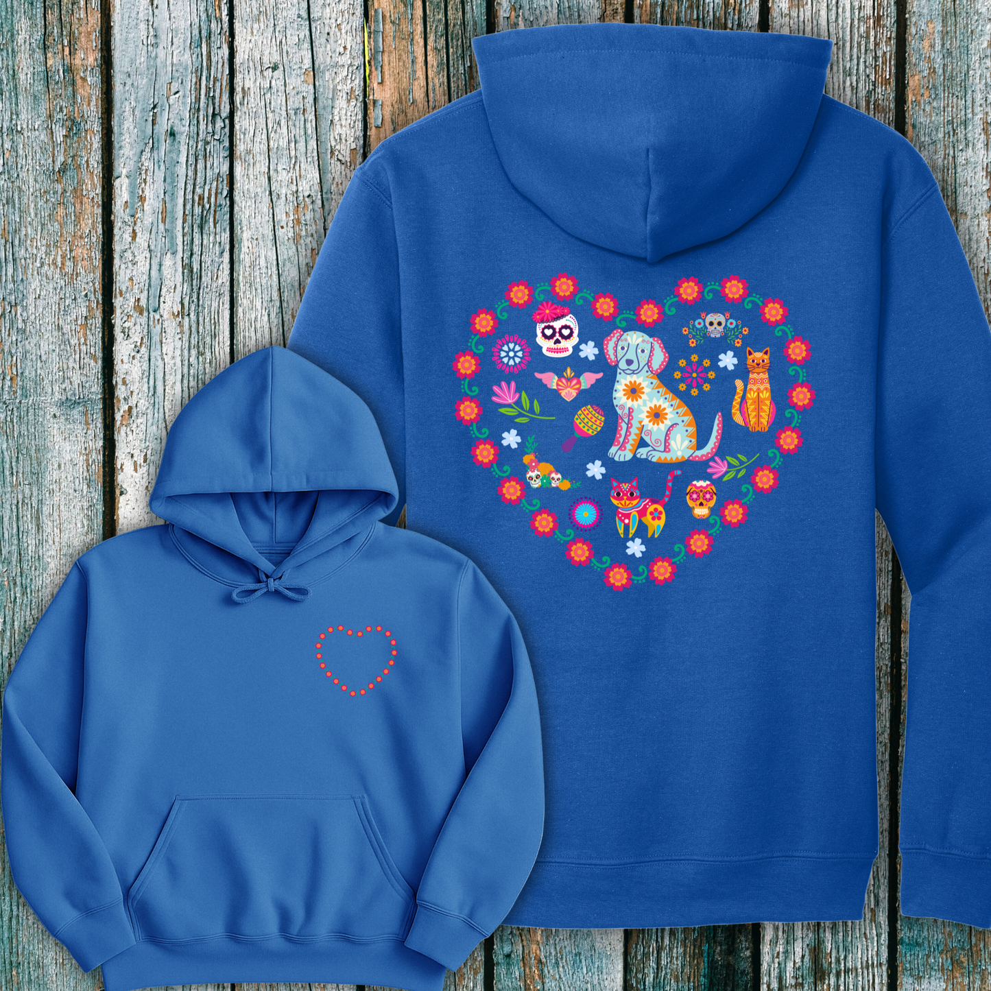Blue hoodie with a day of the dead inspired heart-shaped design on the front and back against a wooden background