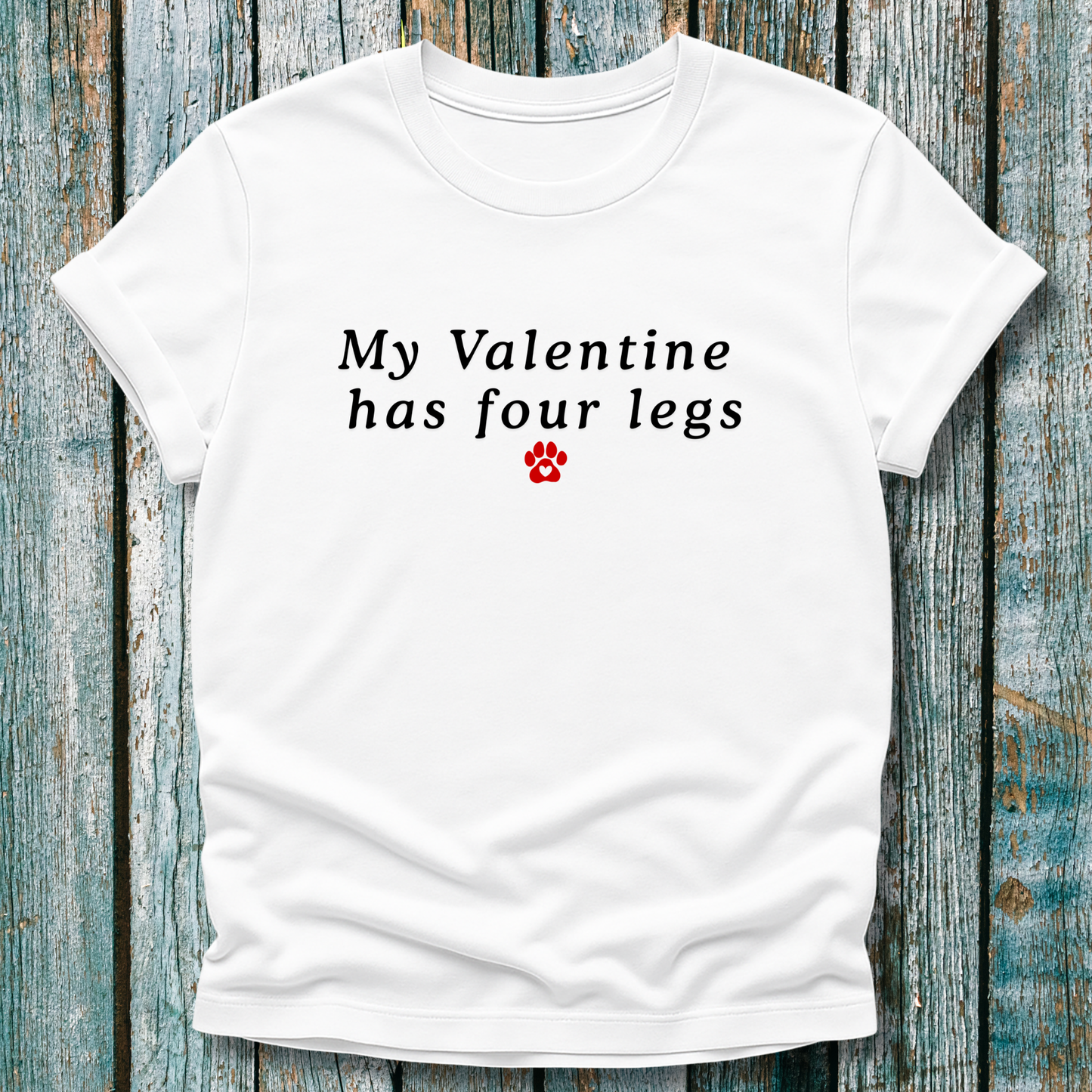 White t-shirt with 'My Valentine has four legs' text on a wooden background