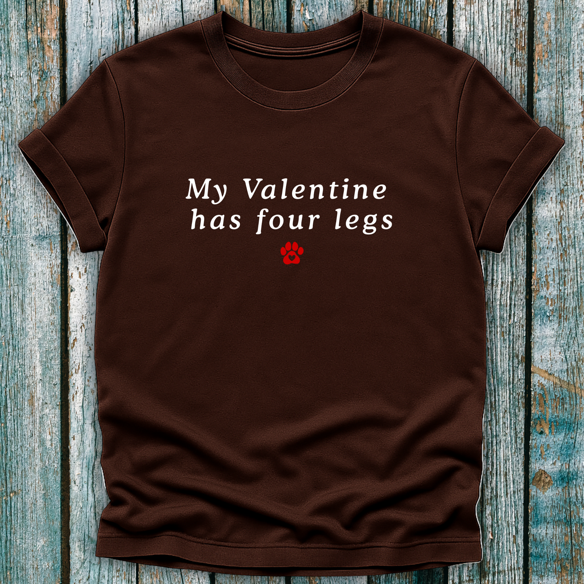 Brown t-shirt with 'My Valentine has four legs' text on a wooden surface