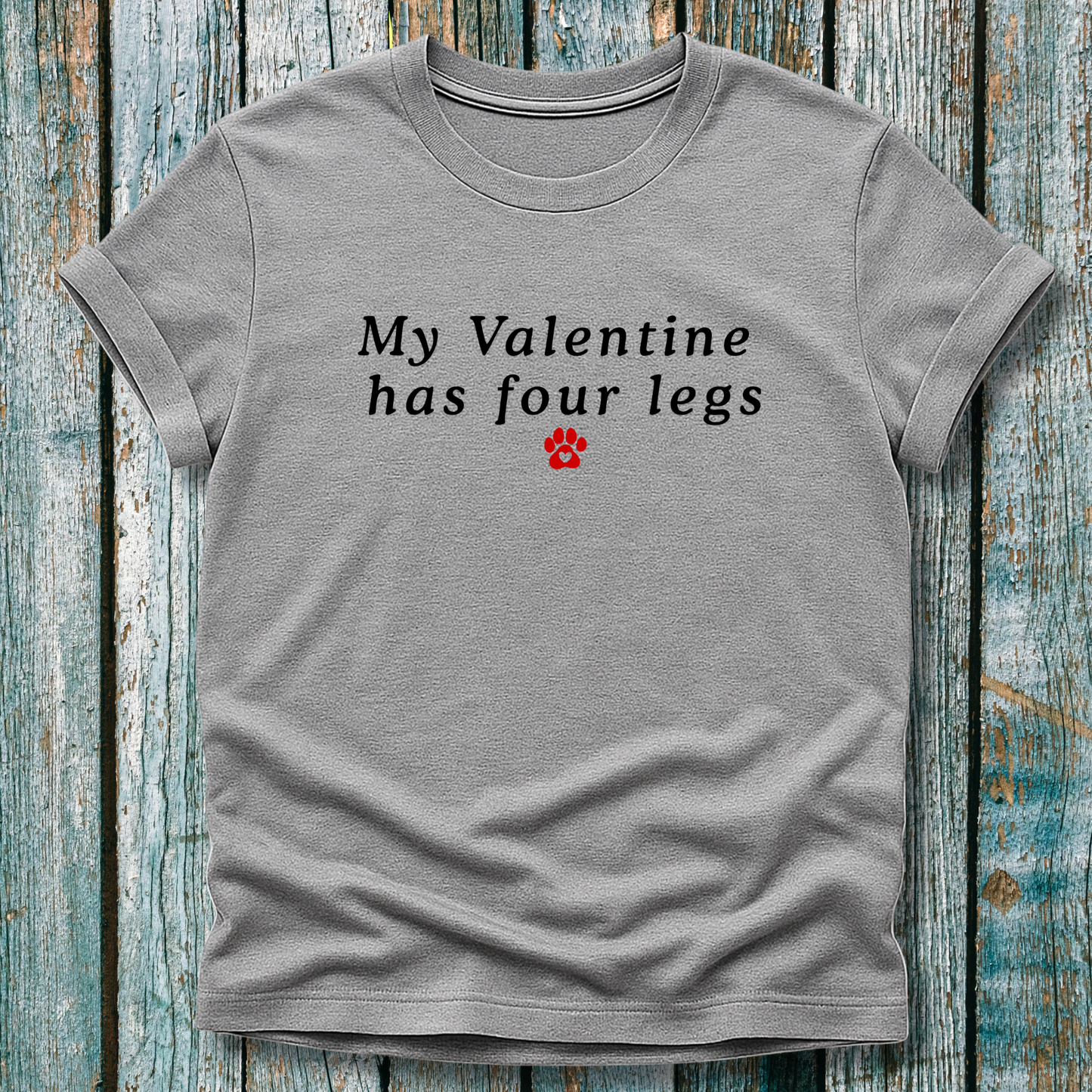 Gray t-shirt with 'My Valentine has four legs' text on a wooden surface
