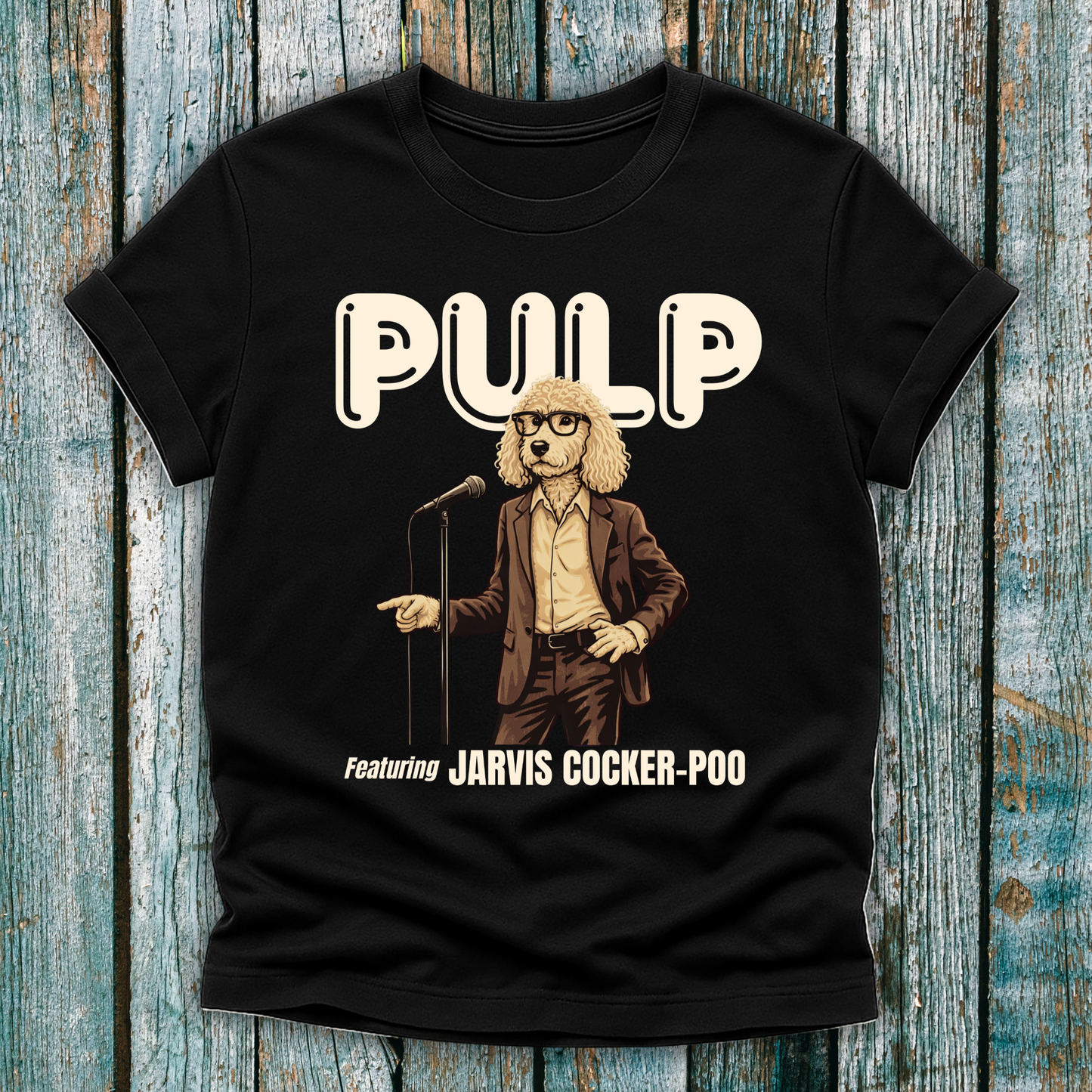  Black T-shirt with a graphic of a dog in a suit and glasses holding a microphone, labeled 'Pulp featuring Jarvis Cocker-Poo' on a wooden background.a