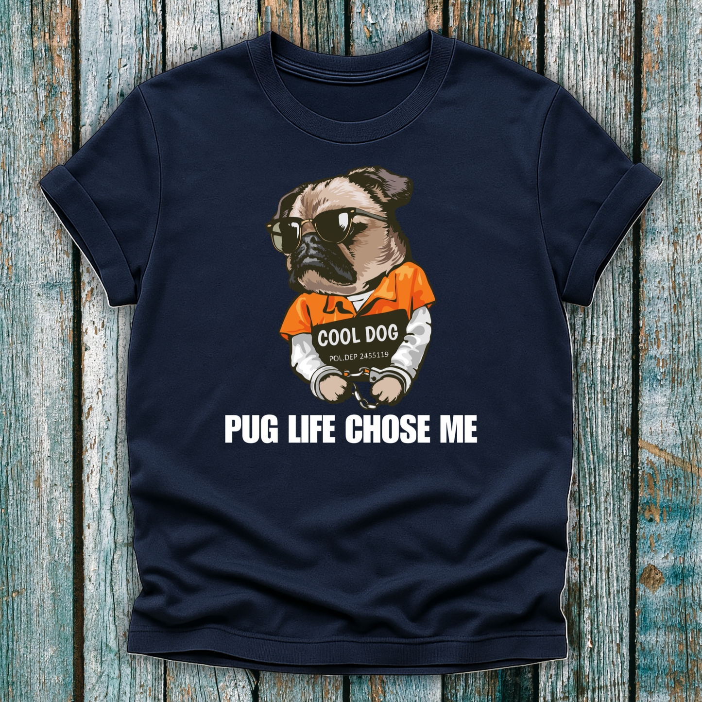 Navy blue t-shirt with a pug graphic and text on a wooden surface
