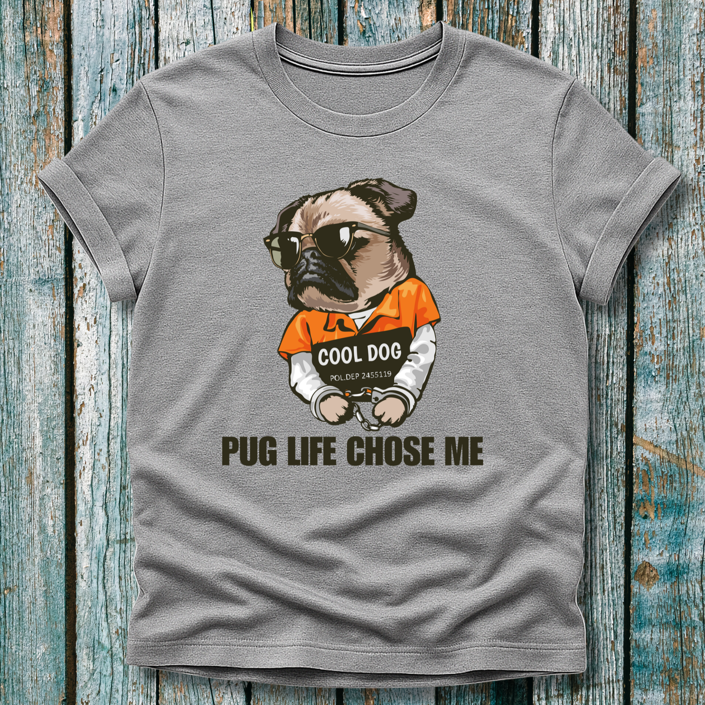 Gray t-shirt with a pug graphic and text on a wooden surface