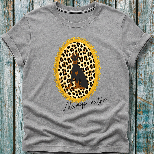 Gray t-shirt with a leopard print design with a Doberman dog and 'Always extra' text on a wooden surface
