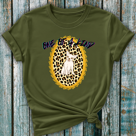 Green t-shirt with a leopard print design and text 'One of a Kind' and a Chihuahua dog on a wooden surface