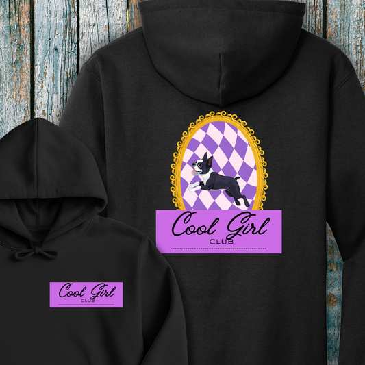 Black hoodie with 'Cool Girl Club' graphic on a wooden background