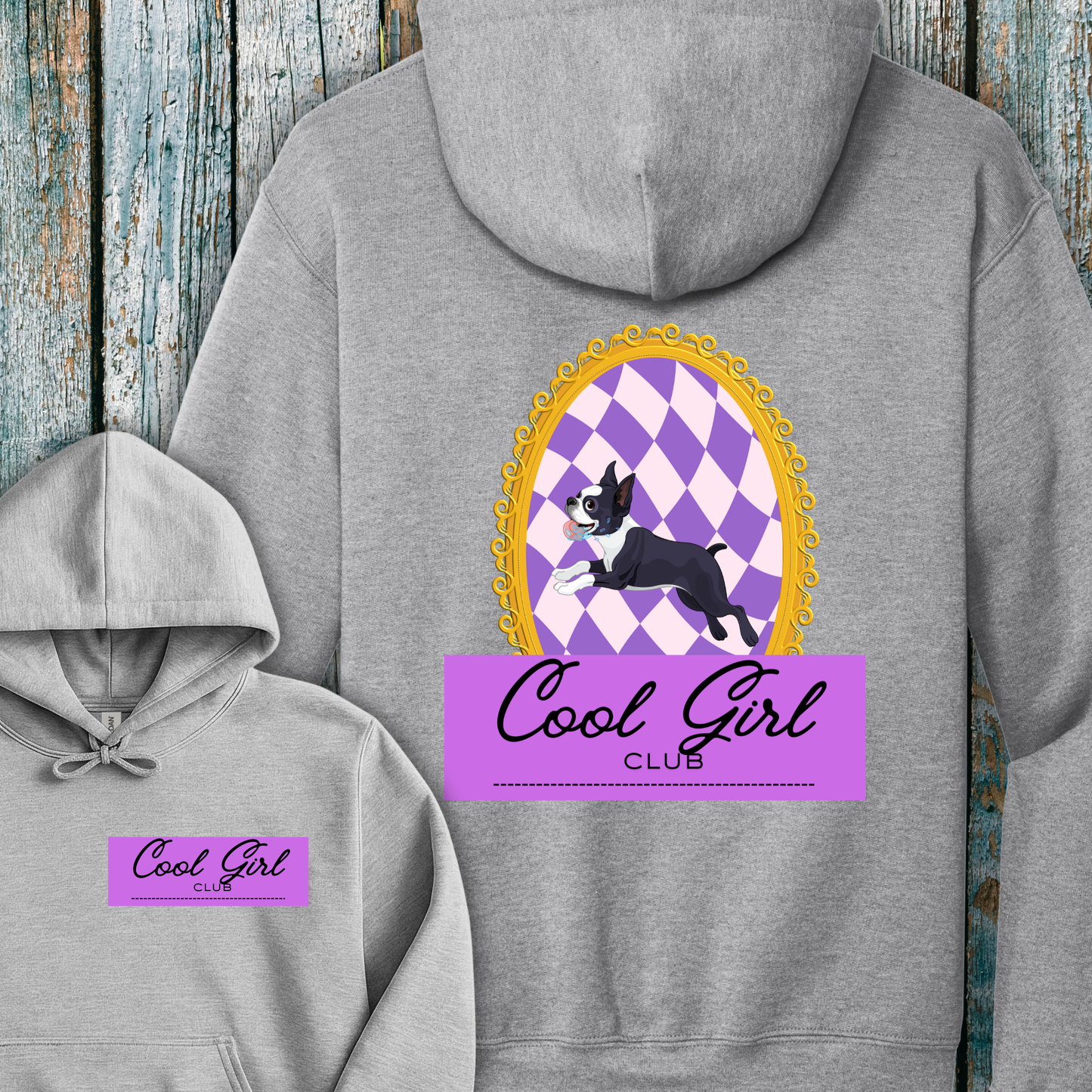 Gray hoodie with 'Cool Girl Club' design on a wooden background