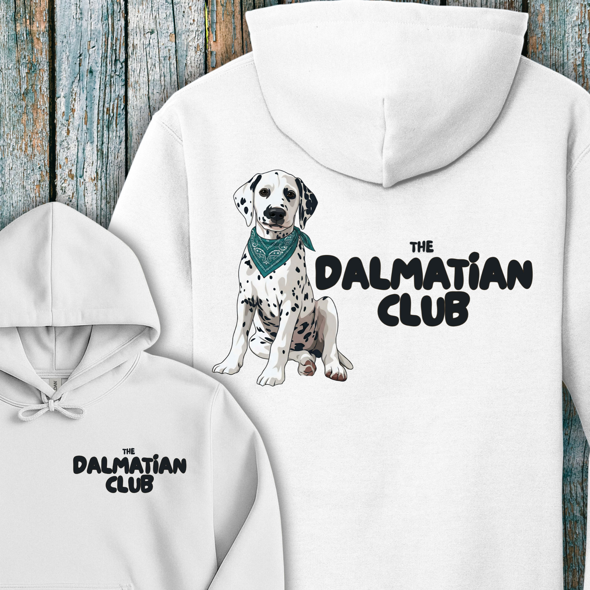 White hoodie with Dalmatian illustration and 'The Dalmatian Club' text on a wooden background
