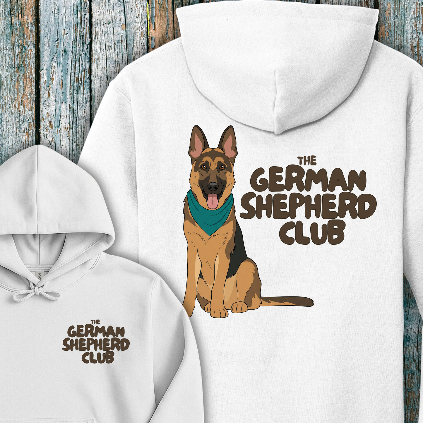 White hoodie with a German Shepherd design and 'The German Shepherd Club' text on a wooden background