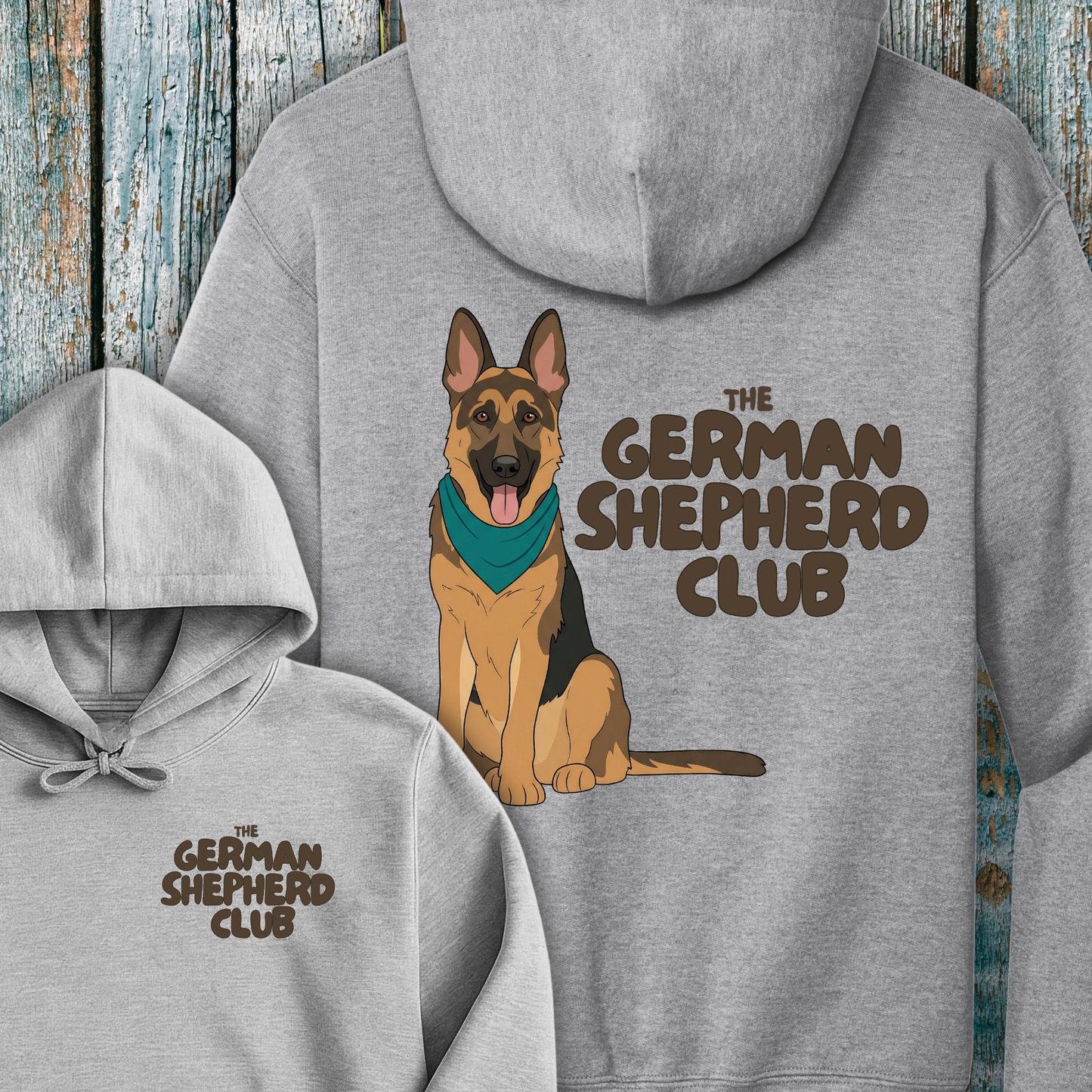 Gray hoodie with a German Shepherd design and 'The German Shepherd Club' text on a wooden background