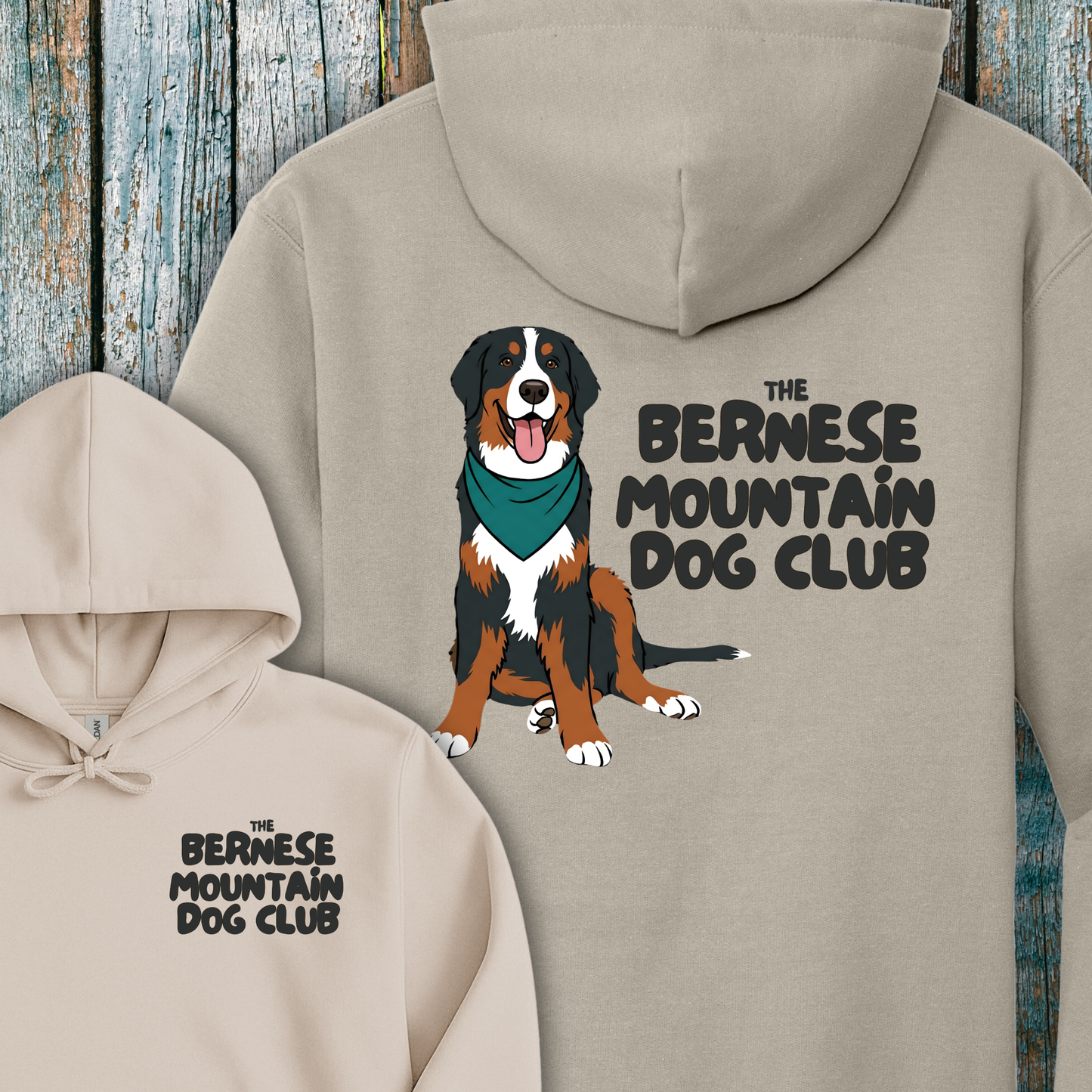 Beige hoodie with Bernese Mountain Dog illustration and text on a wooden background