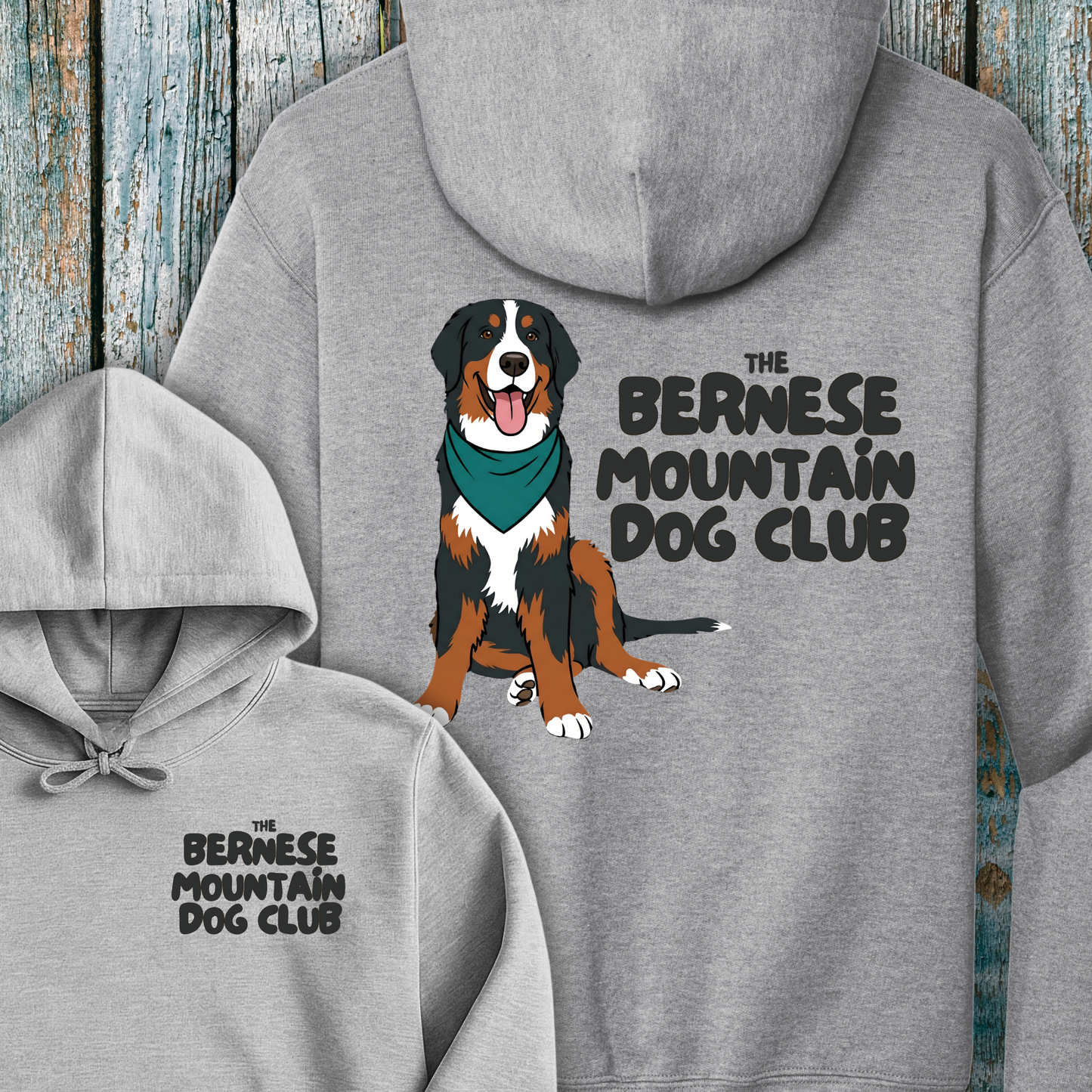 Gray hoodie with Bernese Mountain Dog illustration and text on a wooden background