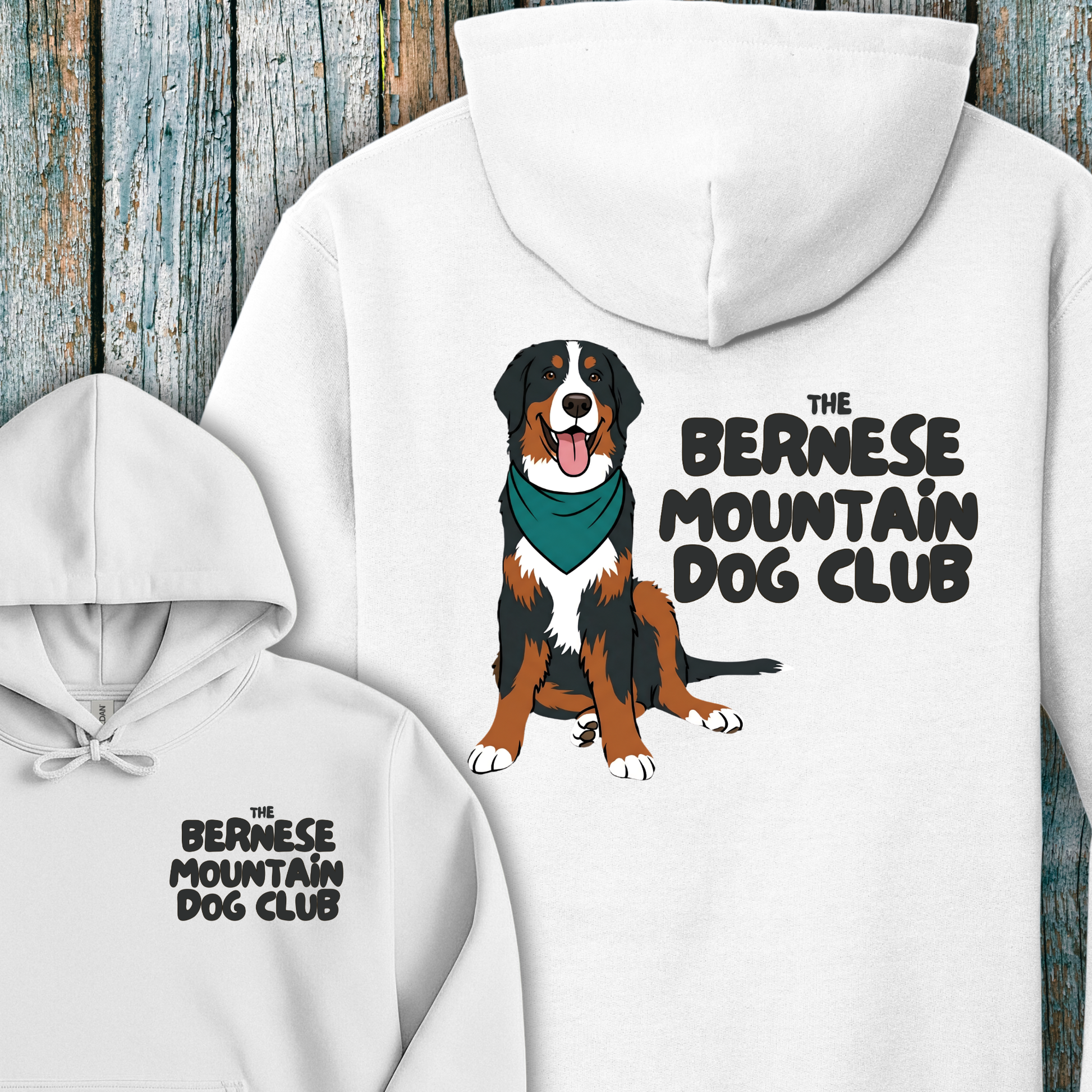 White hoodie with Bernese Mountain Dog illustration and text on a wooden background