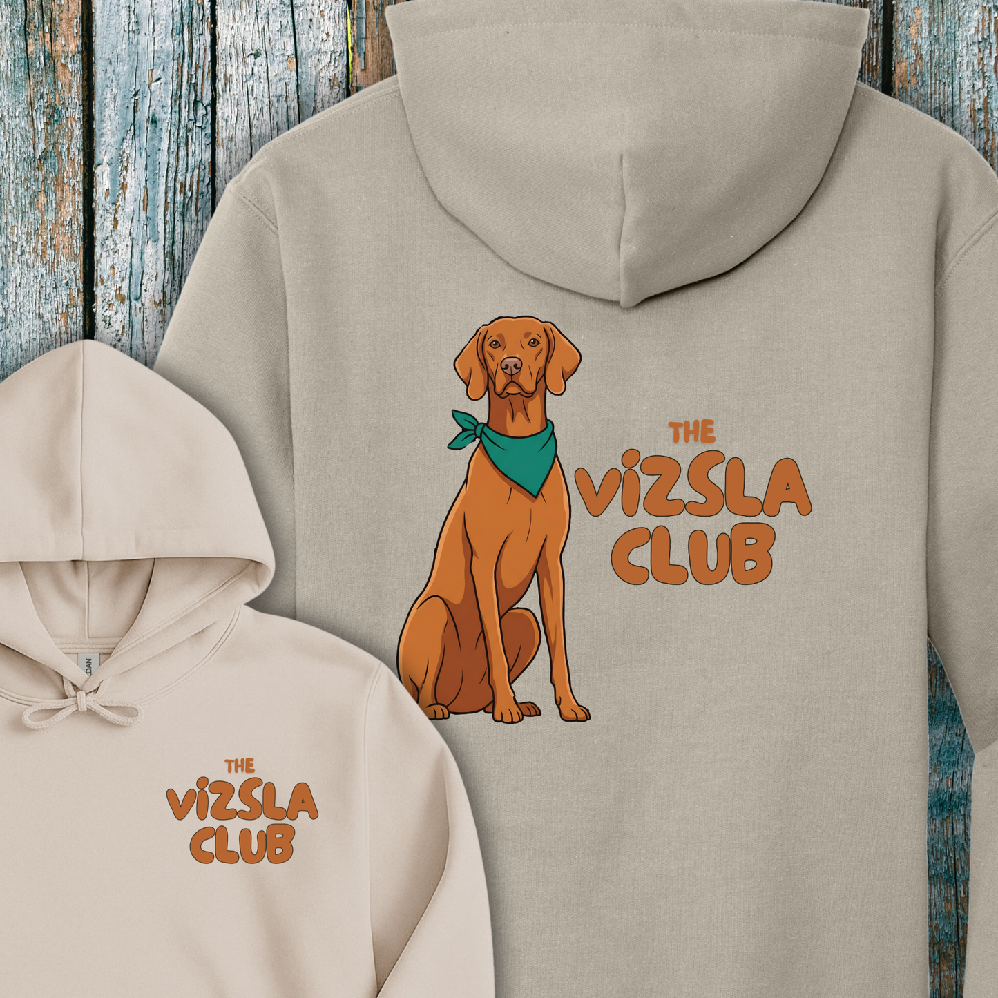 Beige hoodie with a Vizsla dog graphic and 'The Vizsla Club' text on a wooden background