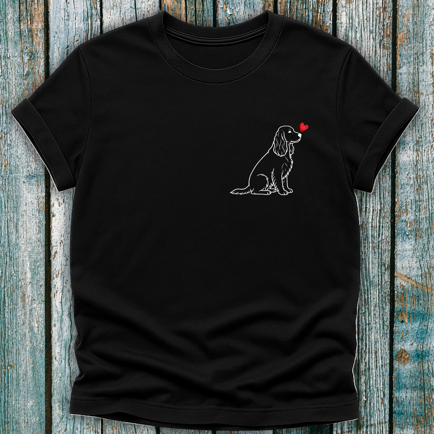 Black t-shirt with a Spaniel dog illustration and red heart on a wooden surface