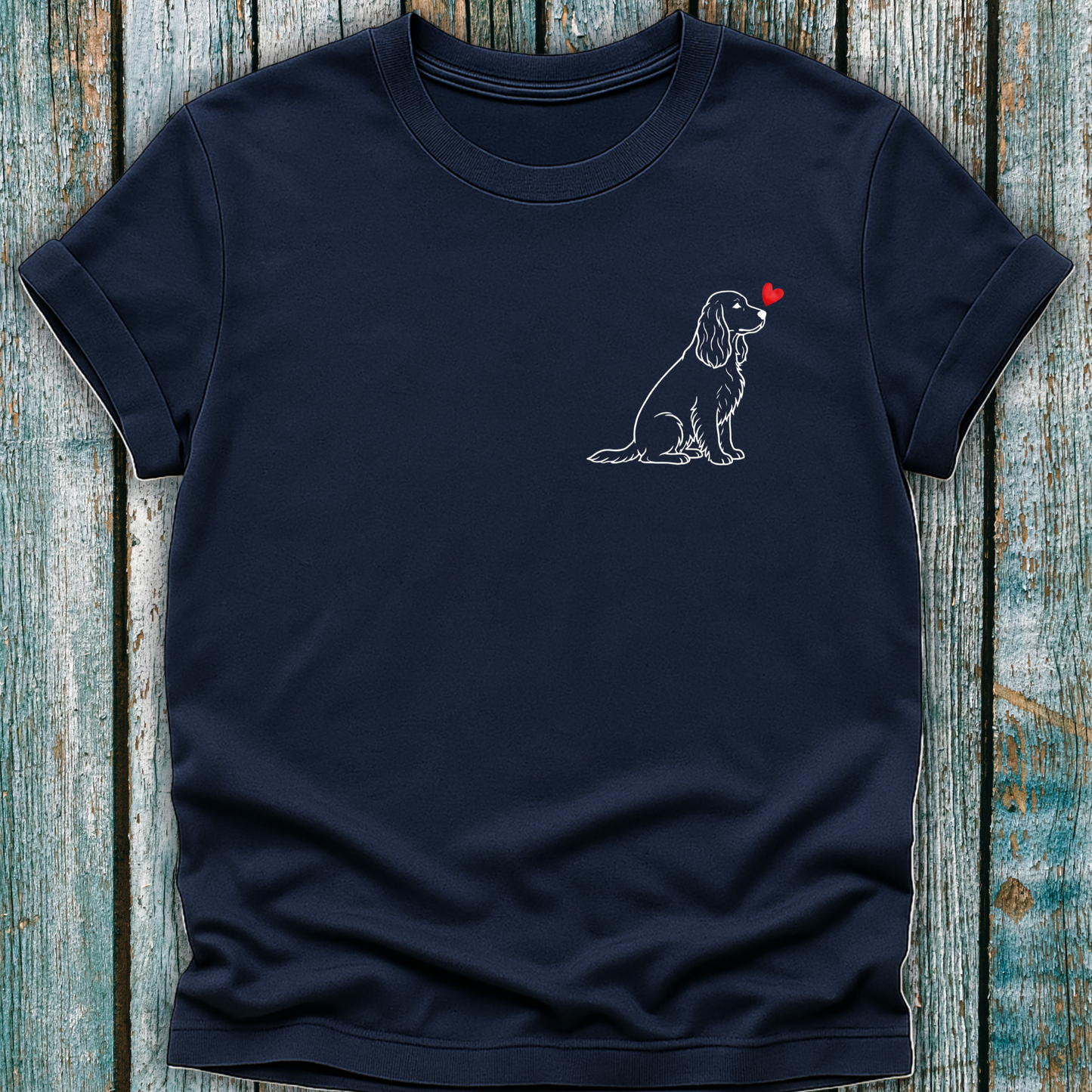 Navy blue t-shirt with a Spaniel dog graphic on a wooden surface