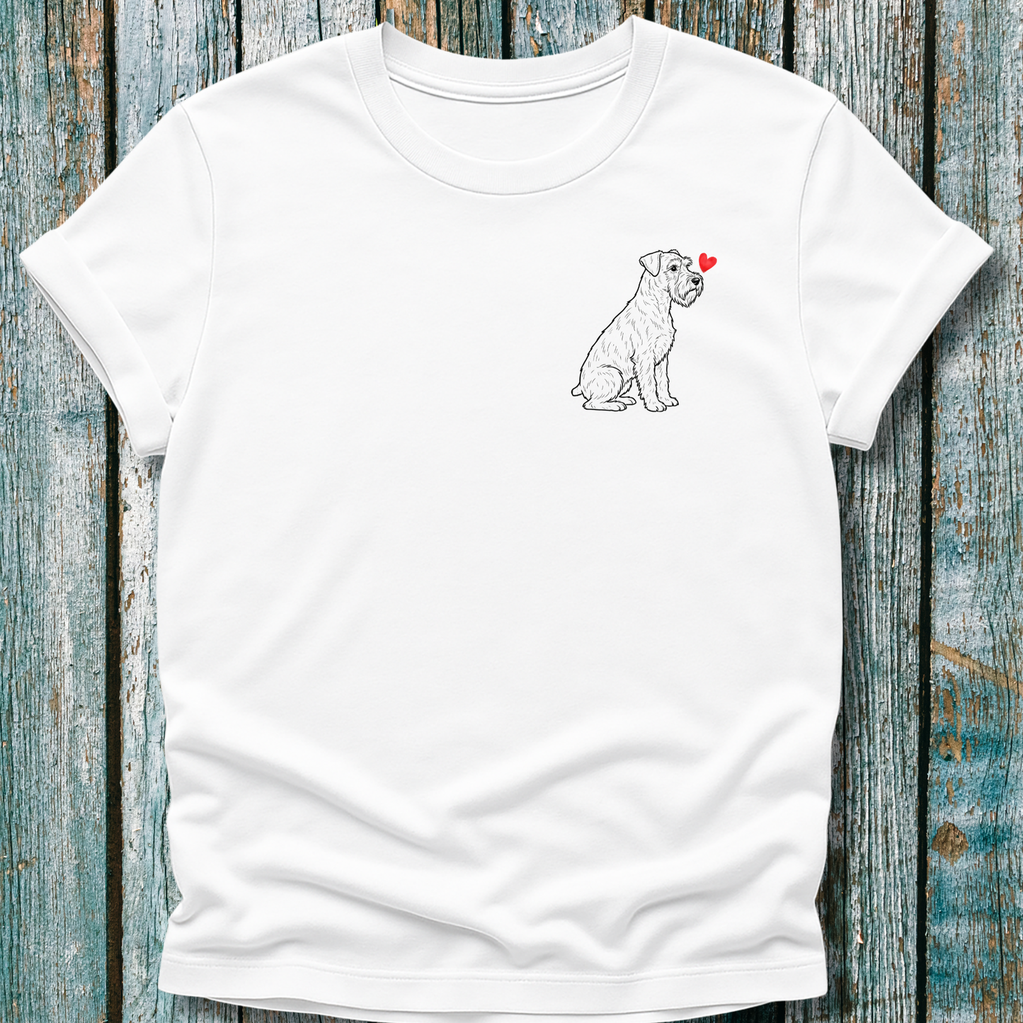 White t-shirt with a Schnauzer dog illustration on a wooden surface