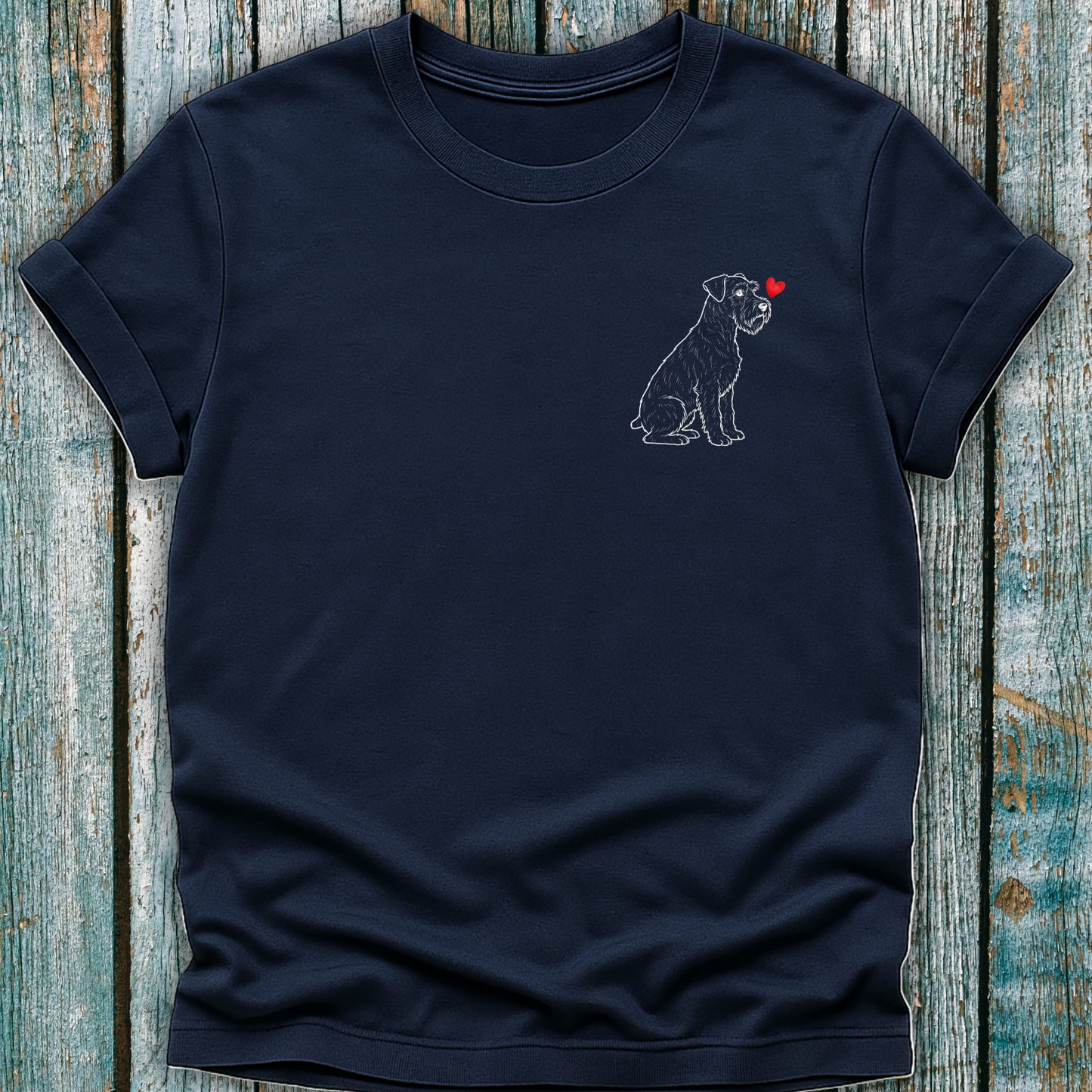 Navy blue t-shirt with a Schnauzer dog and red heart design on a wooden surface