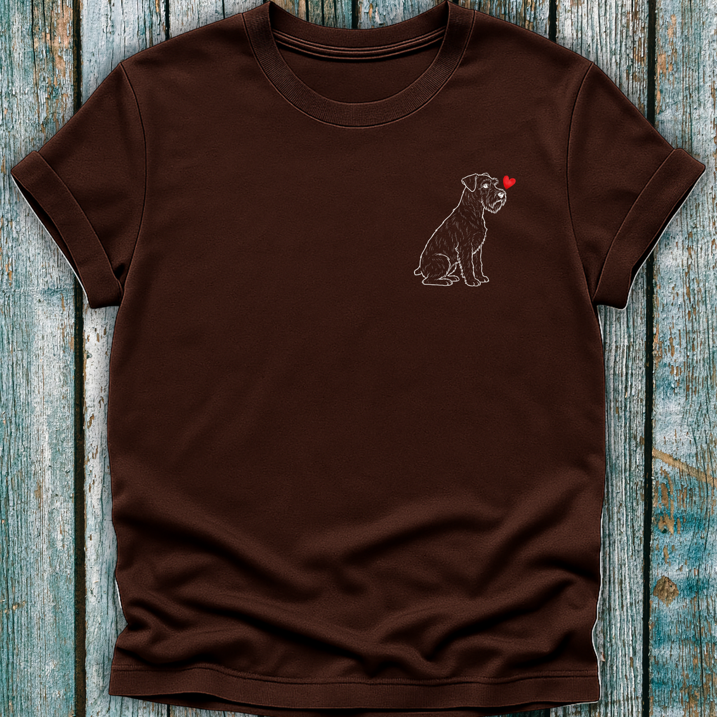 Brown t-shirt with a Schnauzer dog graphic on a wooden surface