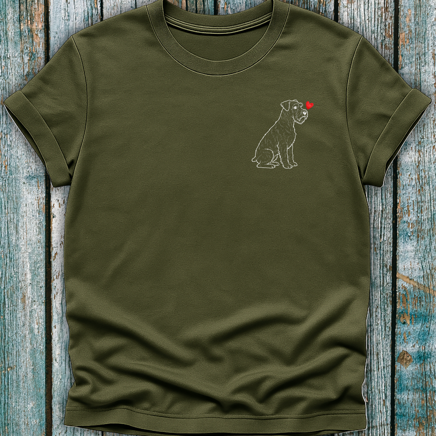 Green t-shirt with a Schnauzer dog and heart design on a wooden surface