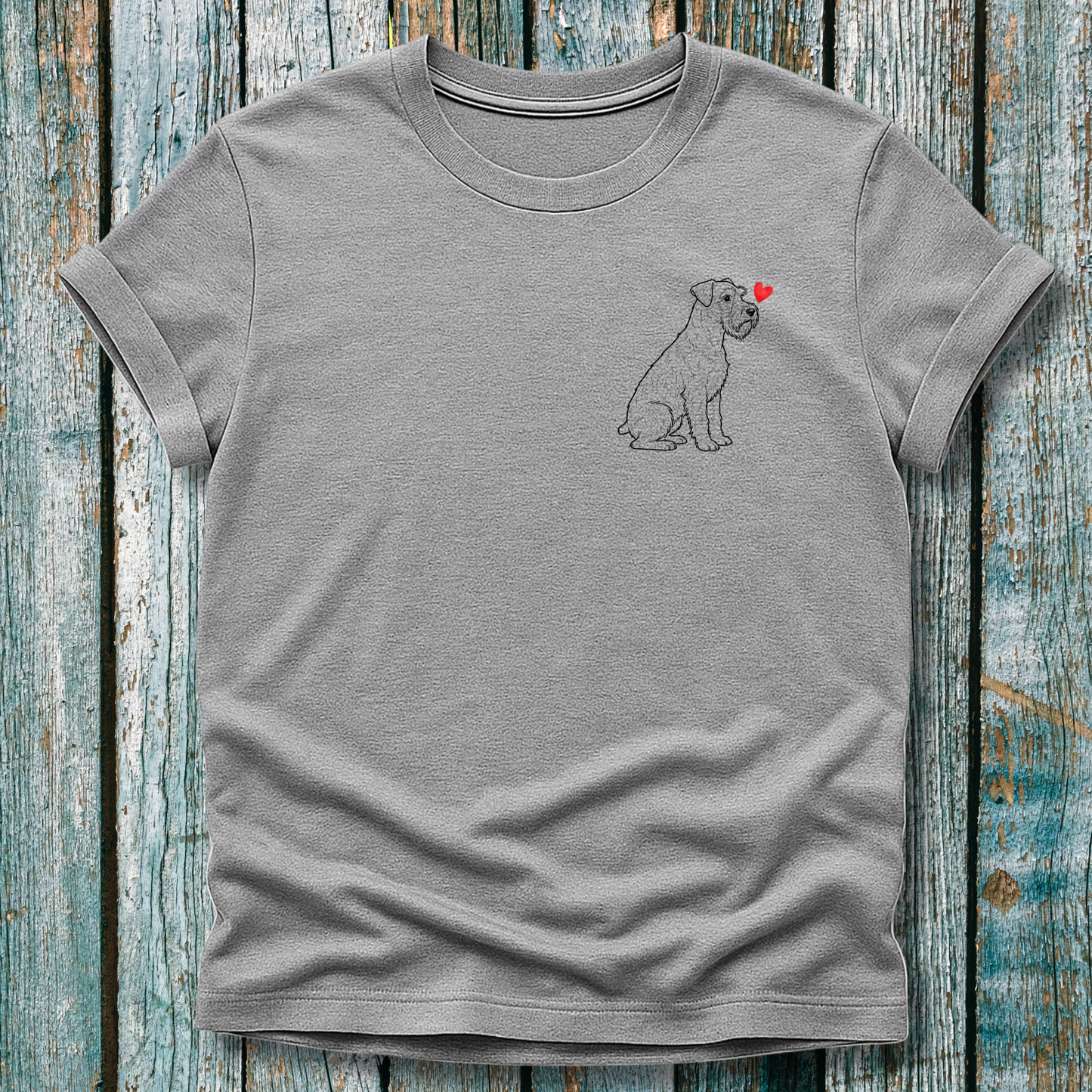 Gray t-shirt with a Schnauzer and heart design on a wooden surface
