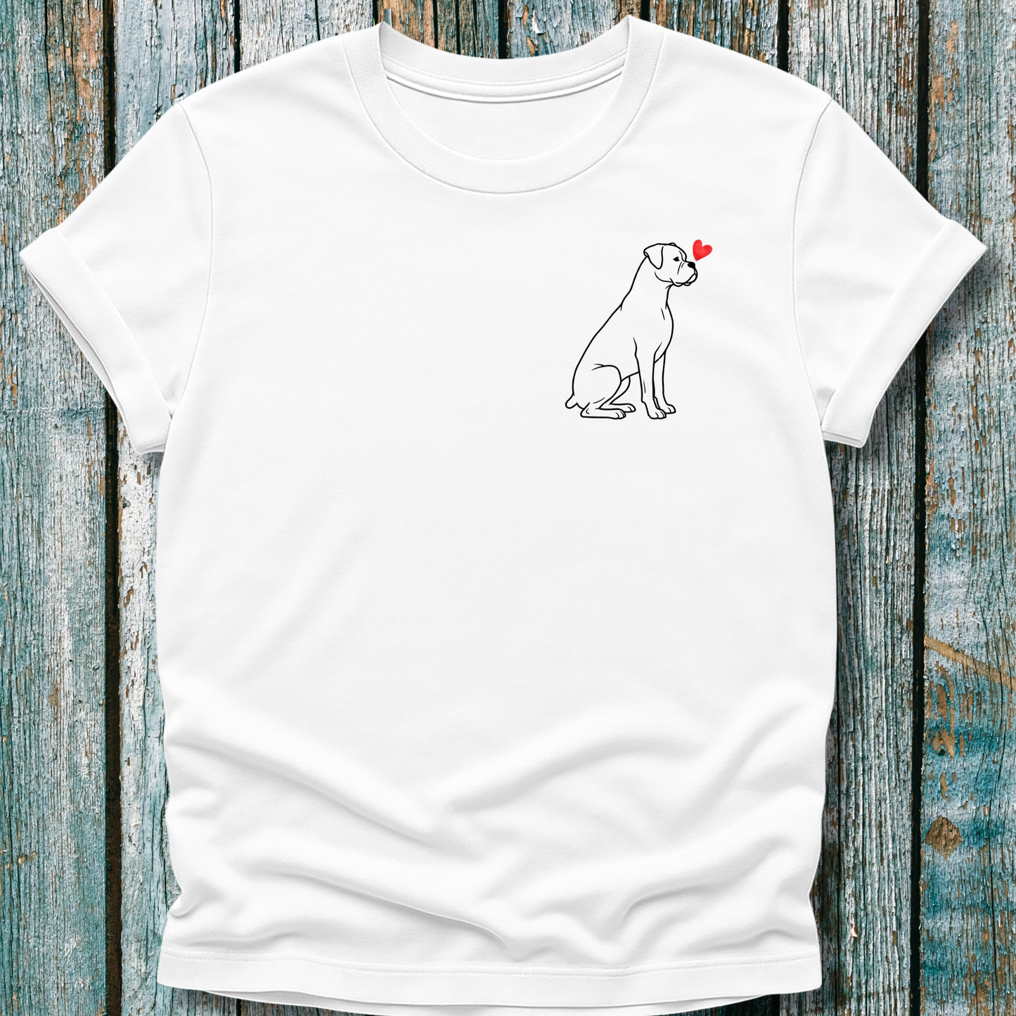 White t-shirt with a Boxer dog graphic and red heart on a wooden surface