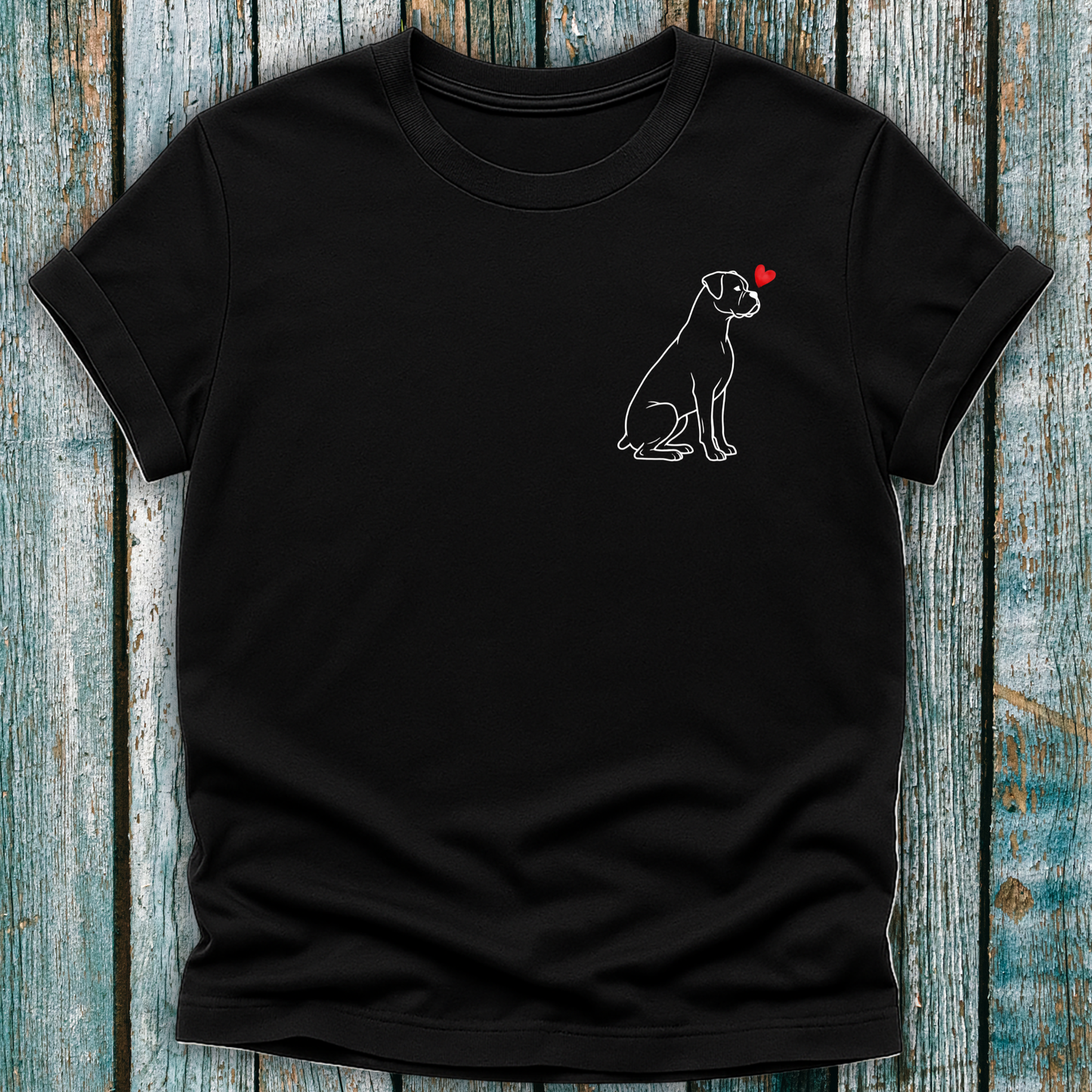 Black t-shirt with a Boxer dog graphic on a wooden surface