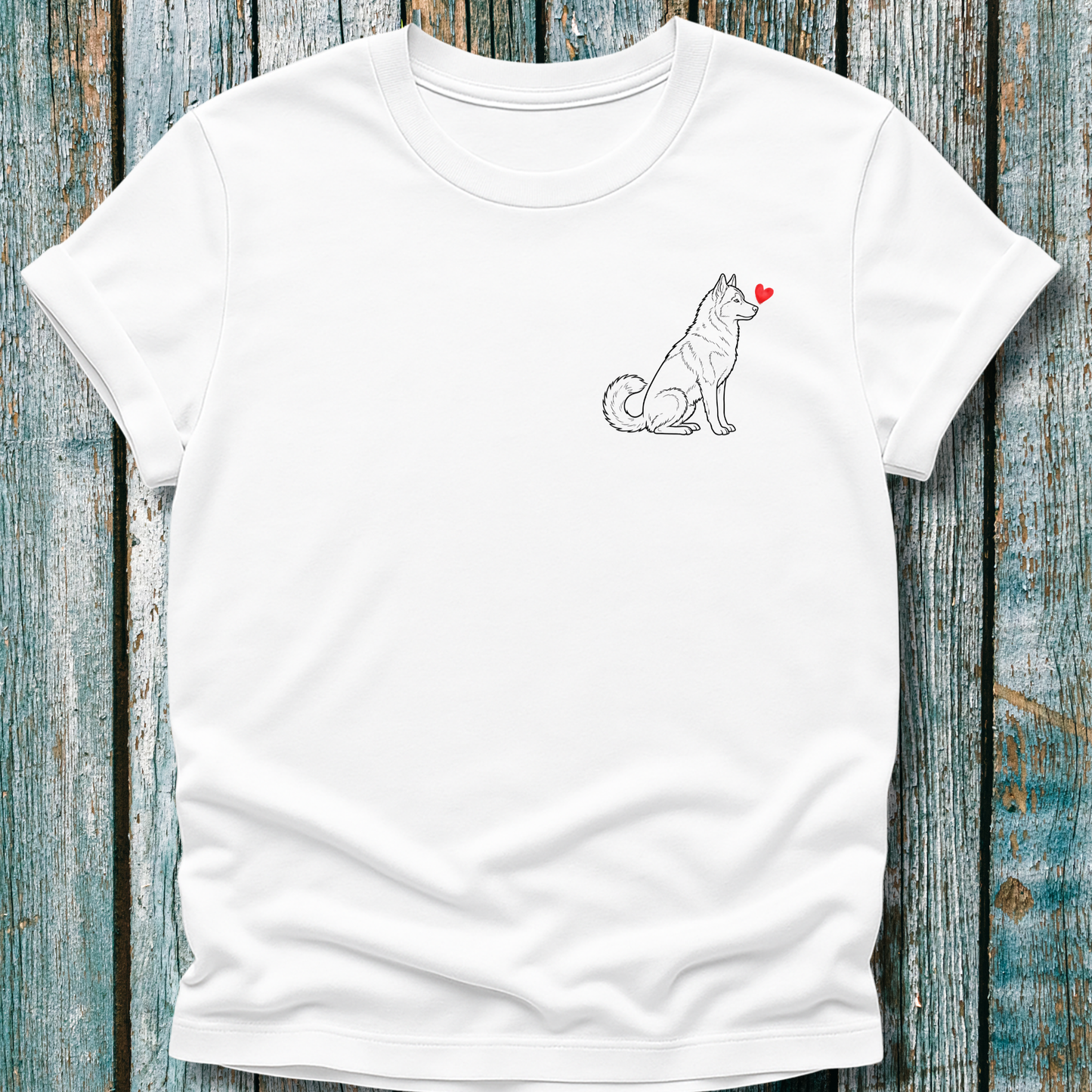 White t-shirt with a Husky dog graphic and red heart on a wooden surface