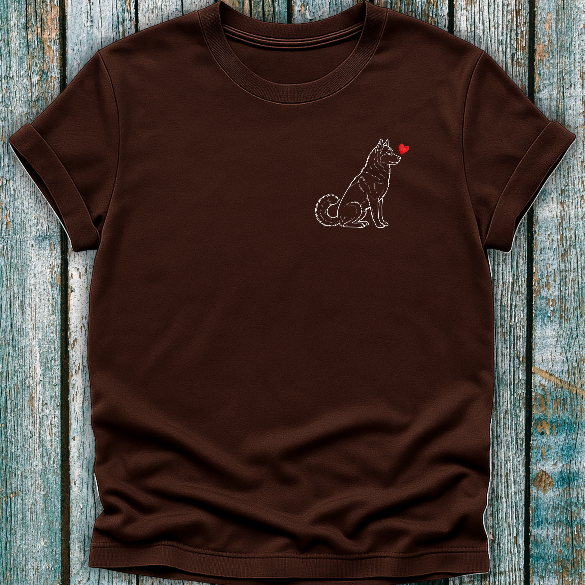 Brown t-shirt with a Husky dog illustration and red heart on a wooden surface