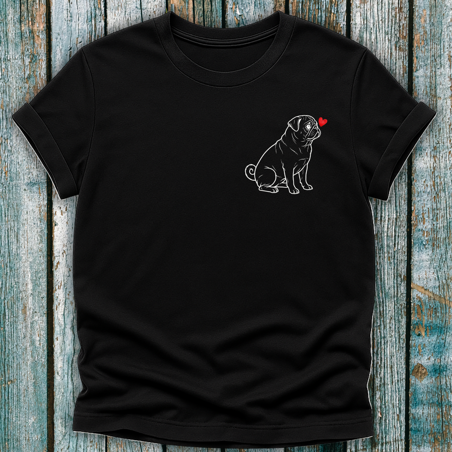 Black t-shirt with a Pug dog graphic on a wooden surface