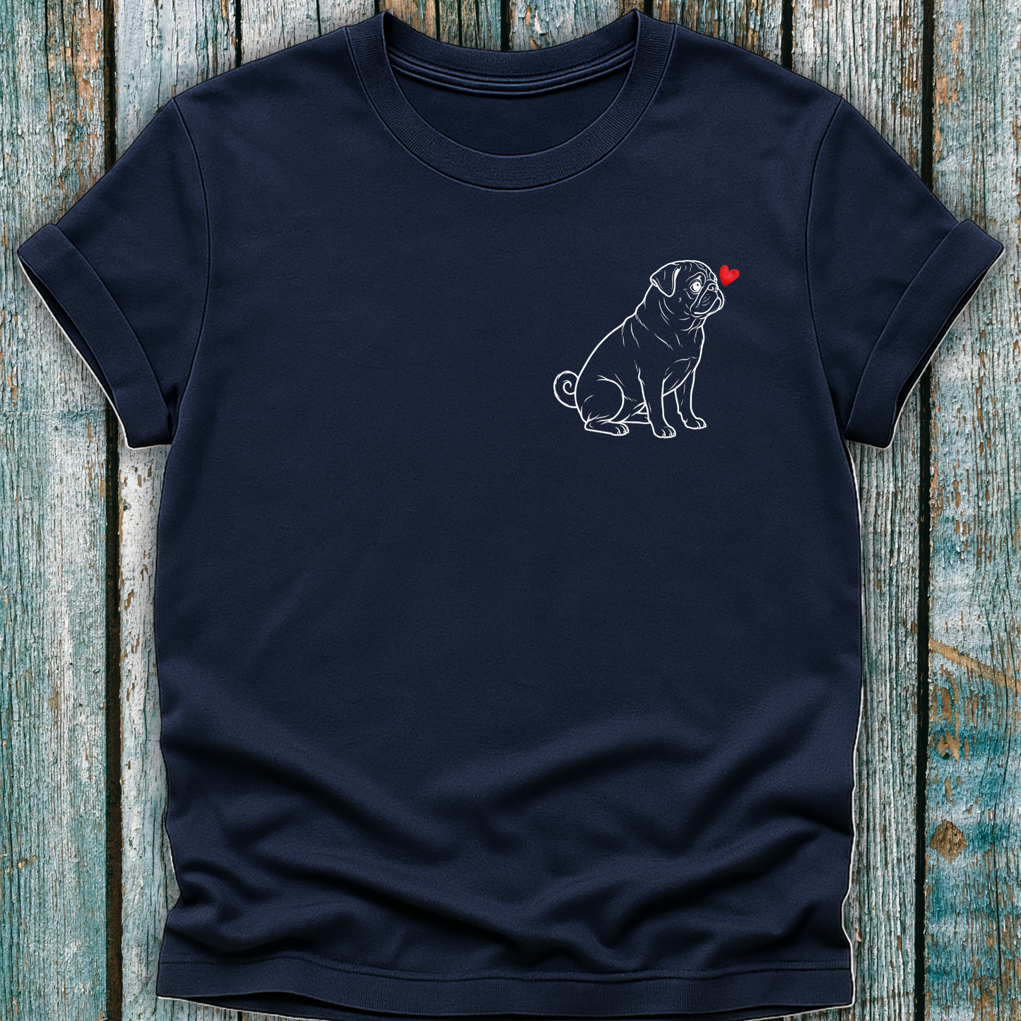 Navy blue t-shirt with a Pug dog and red heart design on a wooden surface