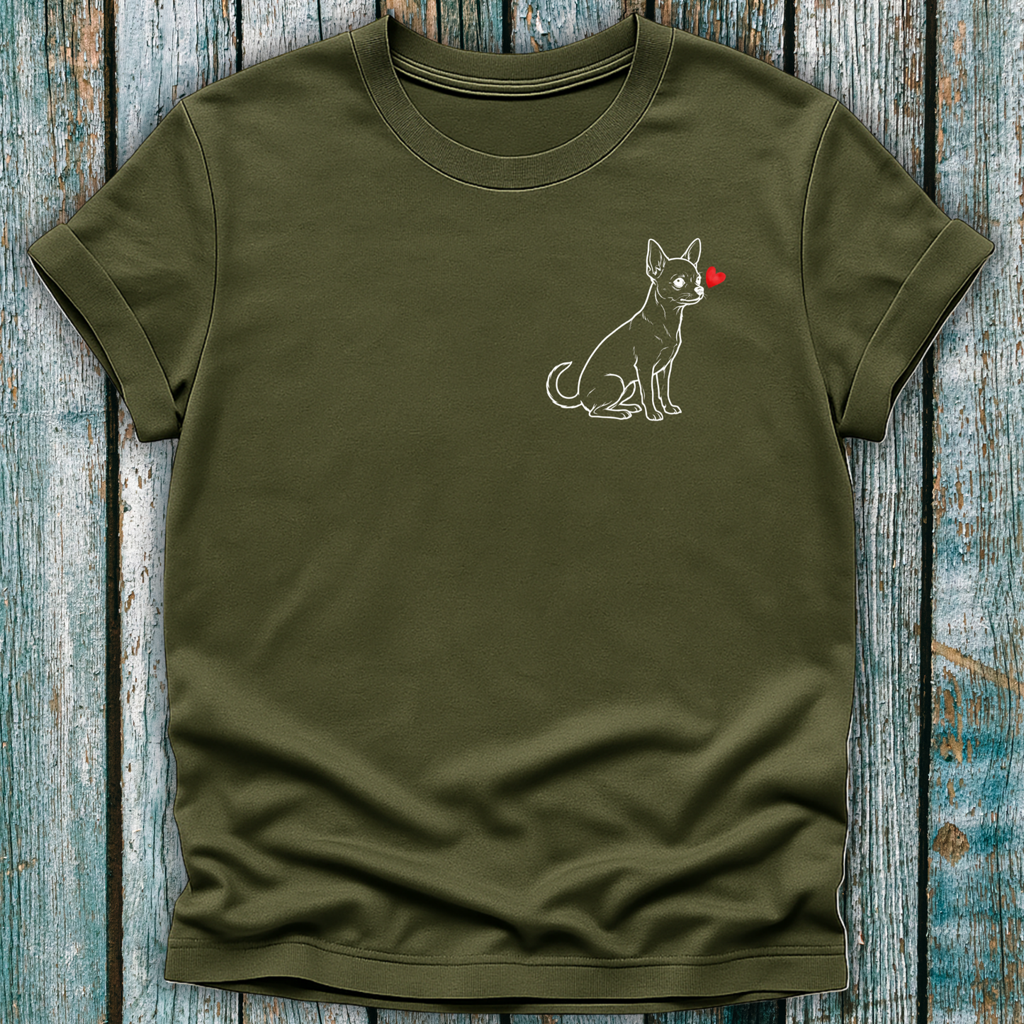 Green t-shirt with a Chihuahua  dog graphic on a wooden surface