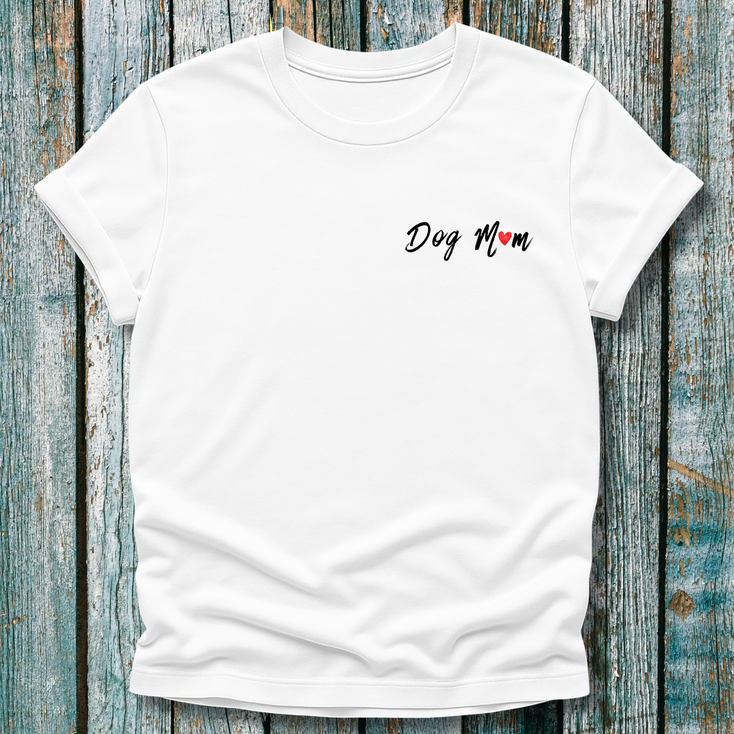 White t-shirt with 'Dog Mom' 'Dog Mum' text on a wooden surface