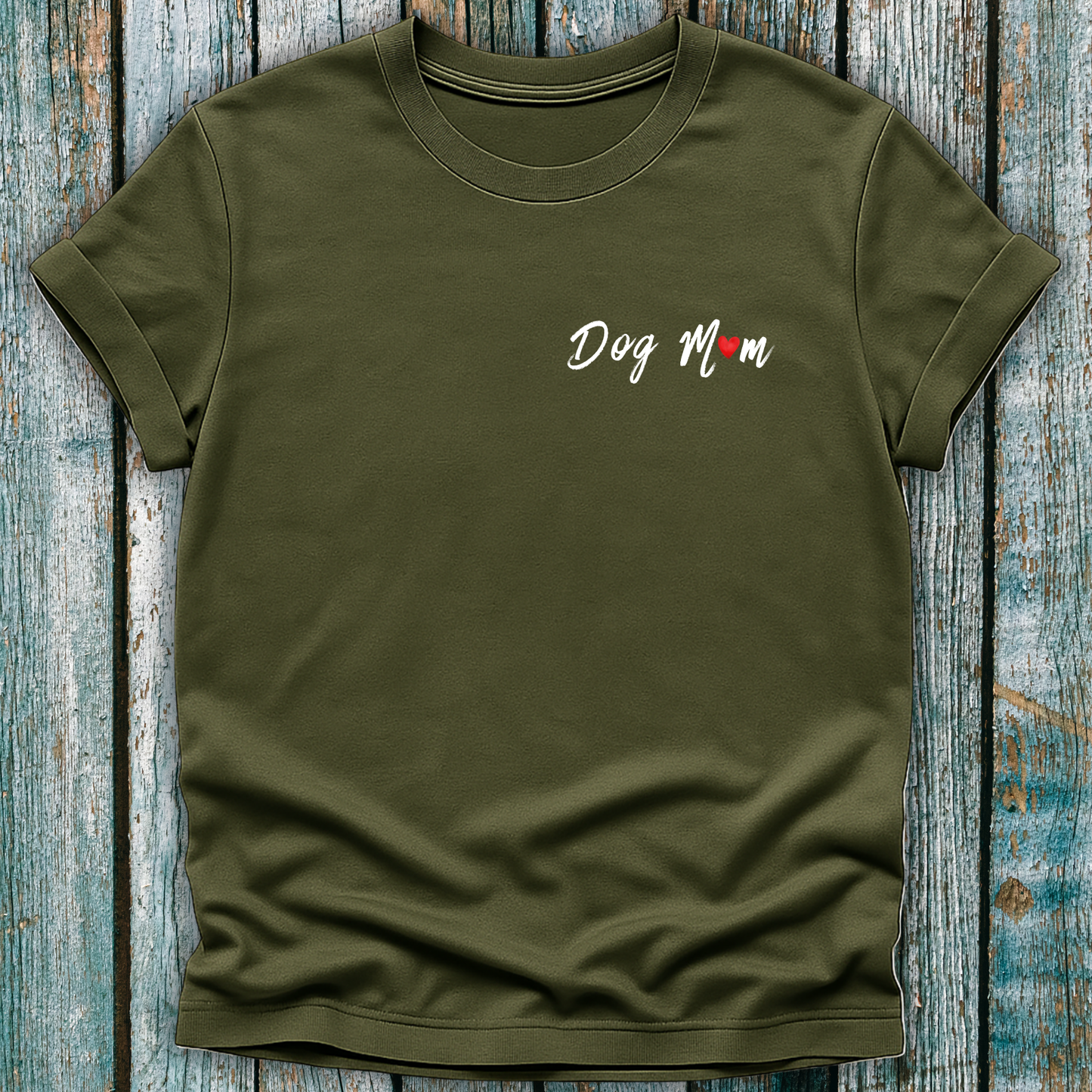 Green t-shirt with 'Dog Mom' 'Dog Mum' text on a wooden surface