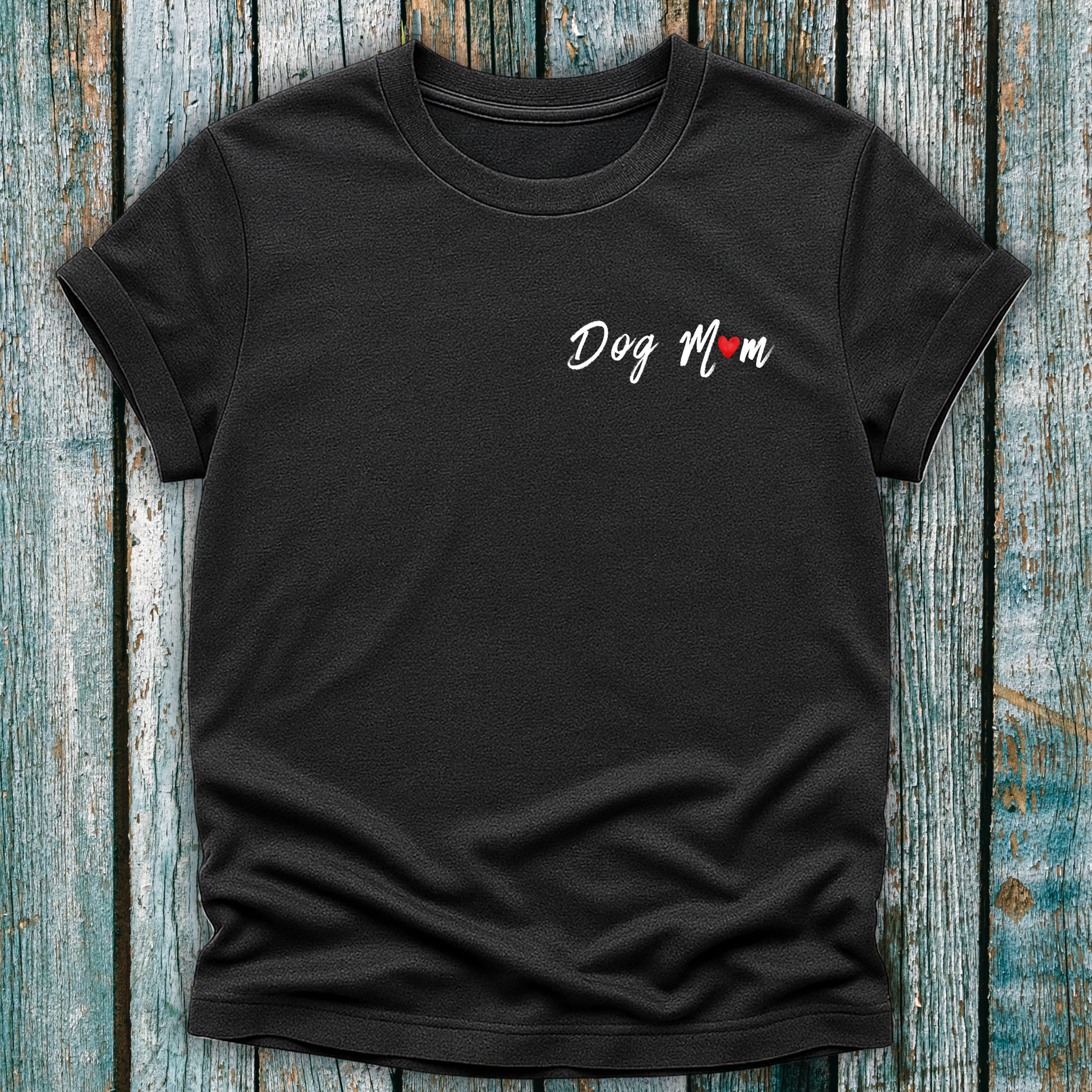Black t-shirt with 'Dog Mom' 'Dog Mum' text on a wooden surface