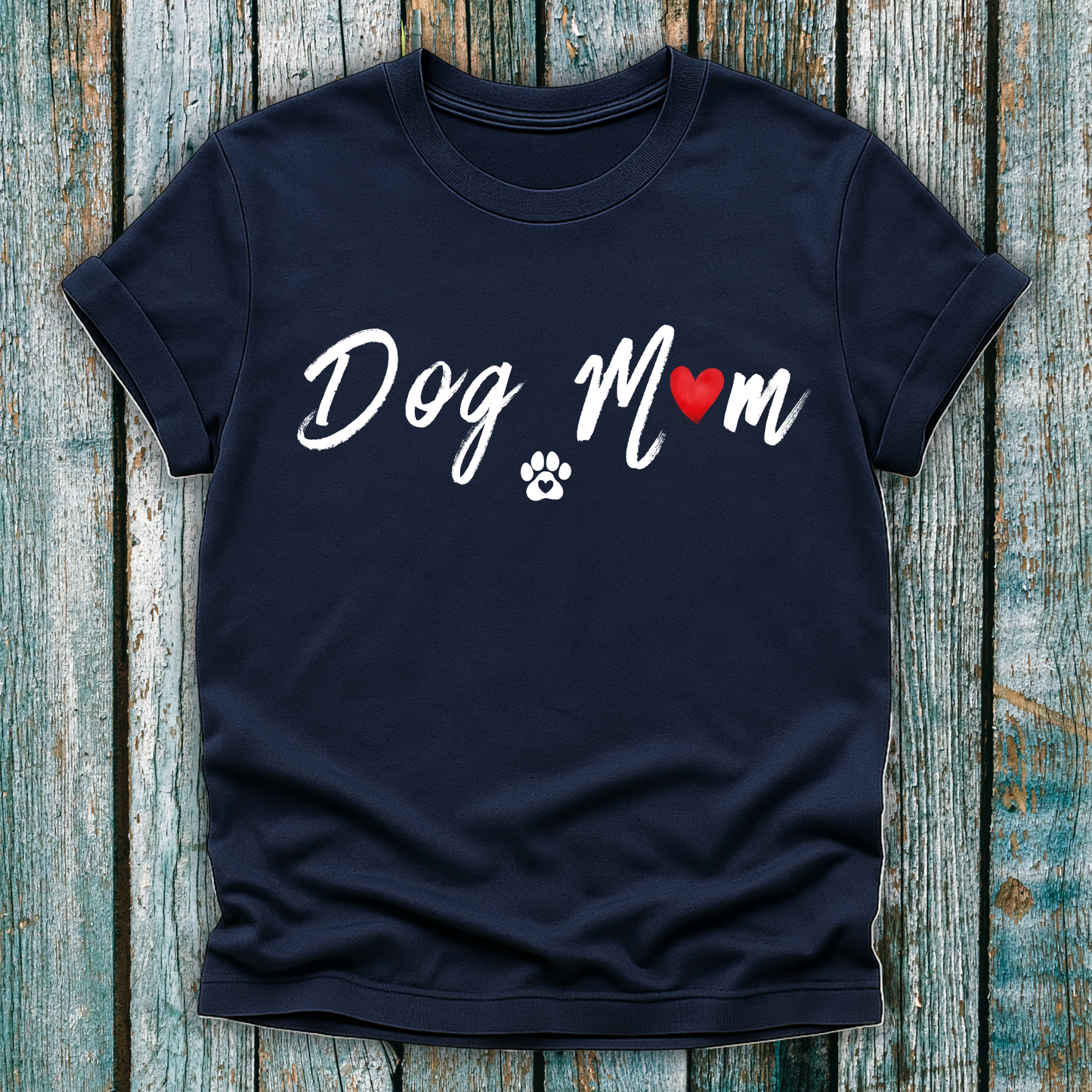 Navy t-shirt with 'Dog Mom' 'Dog Mum' text and heart and paw graphic on a wooden surface